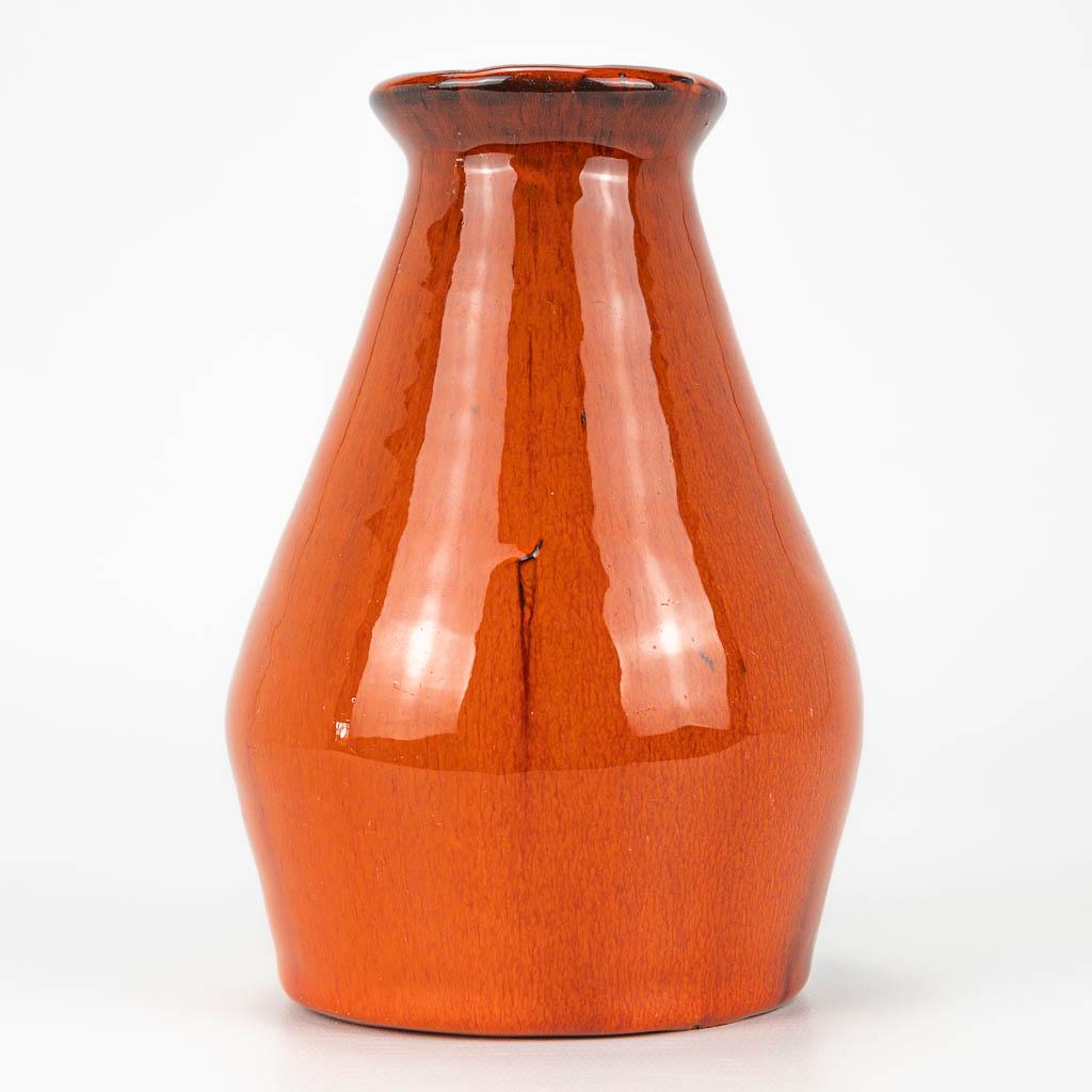 A mid-century vase with orange glaze, in the style of: A mid-century vase with orange glaze, in the style of Amphora, Perignem. (15 x 10 cm)