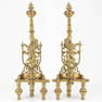 A pair of fireplace andirons made of bronze and