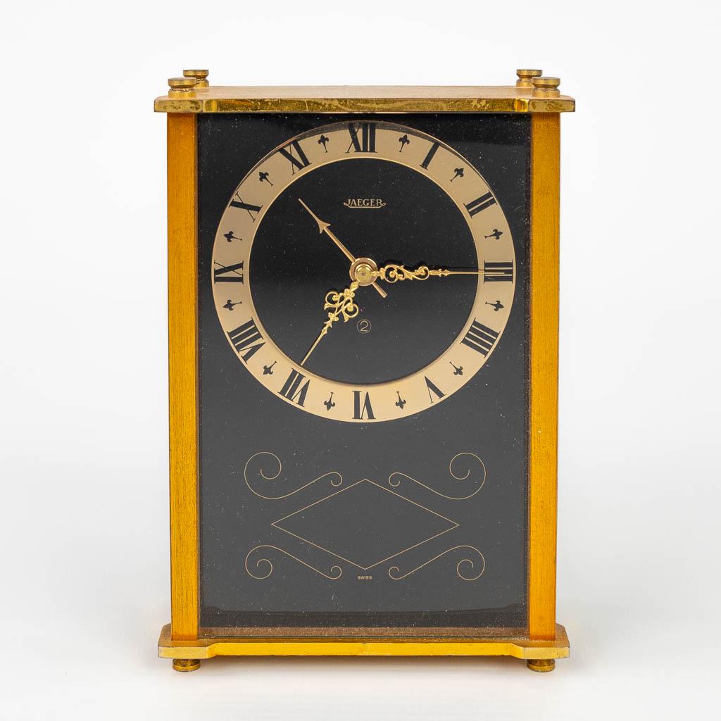 A table alarm clock, marked Jaeger. Made in: A table alarm clock, marked Jaeger. Made of brass and glass in Switzerland during the second half of the 20th century. condition: not in working condition, hand setting knob missing. (4 x 9 x 13 cm)