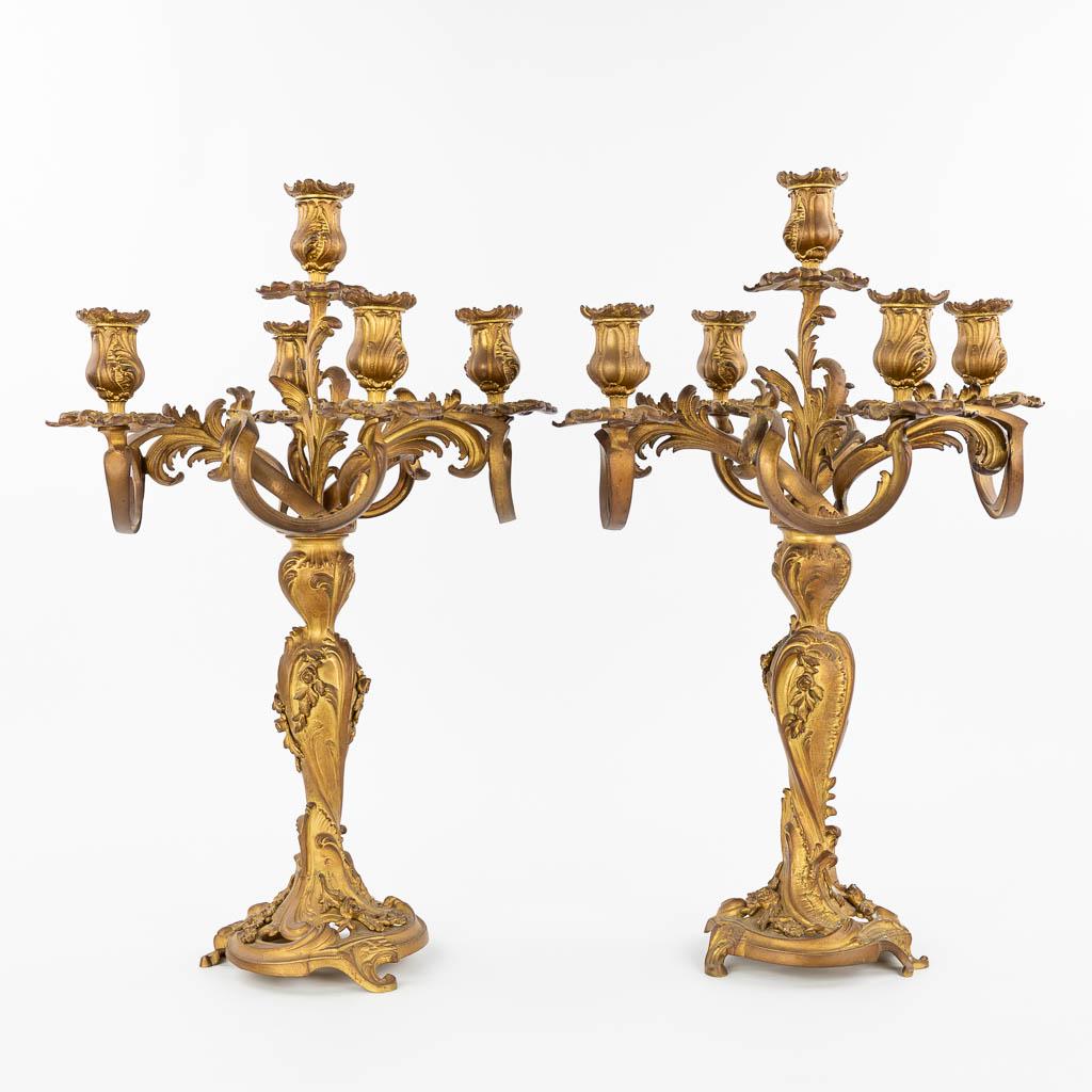 A pair of candelabra made of gilt bronze in Rococo: A pair of candelabra made of gilt bronze in Rococo style. 19th century. (58 x 37 cm)