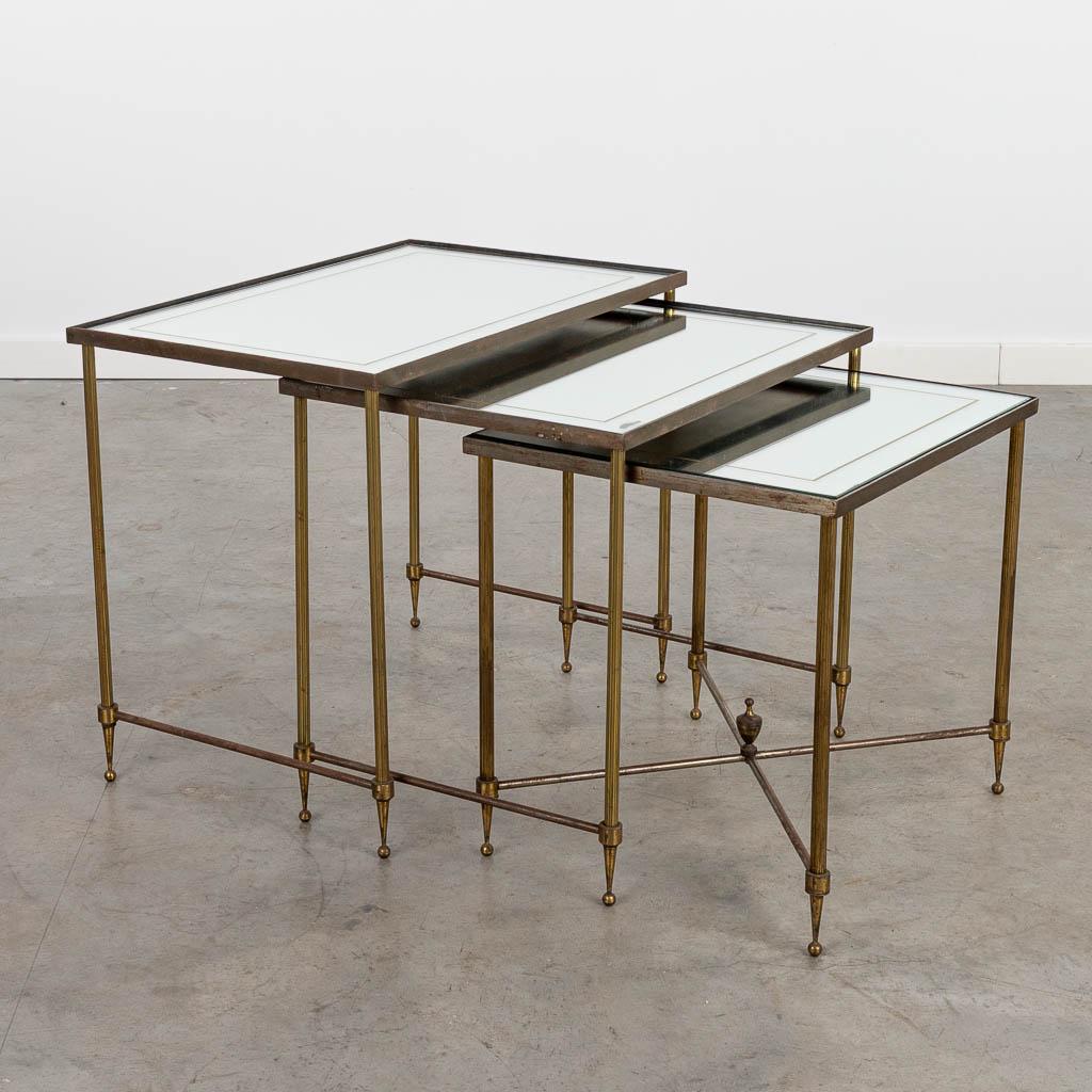 A collection of 3 coffee tables, made of brass and: A collection of 3 coffee tables, made of brass and glass, in the style of Maison Jansen. (35 x 55,5 x 45 cm)
