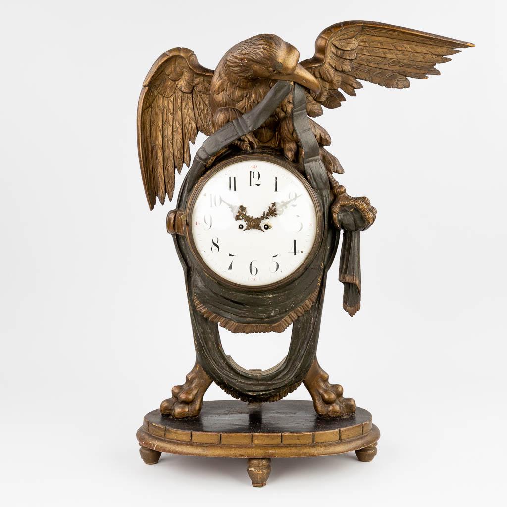 An antique wood sculptured mantle clock with an eagle figurine. 19th C.  (L:22 x W:52 x H:73 cm) (1 of 15)