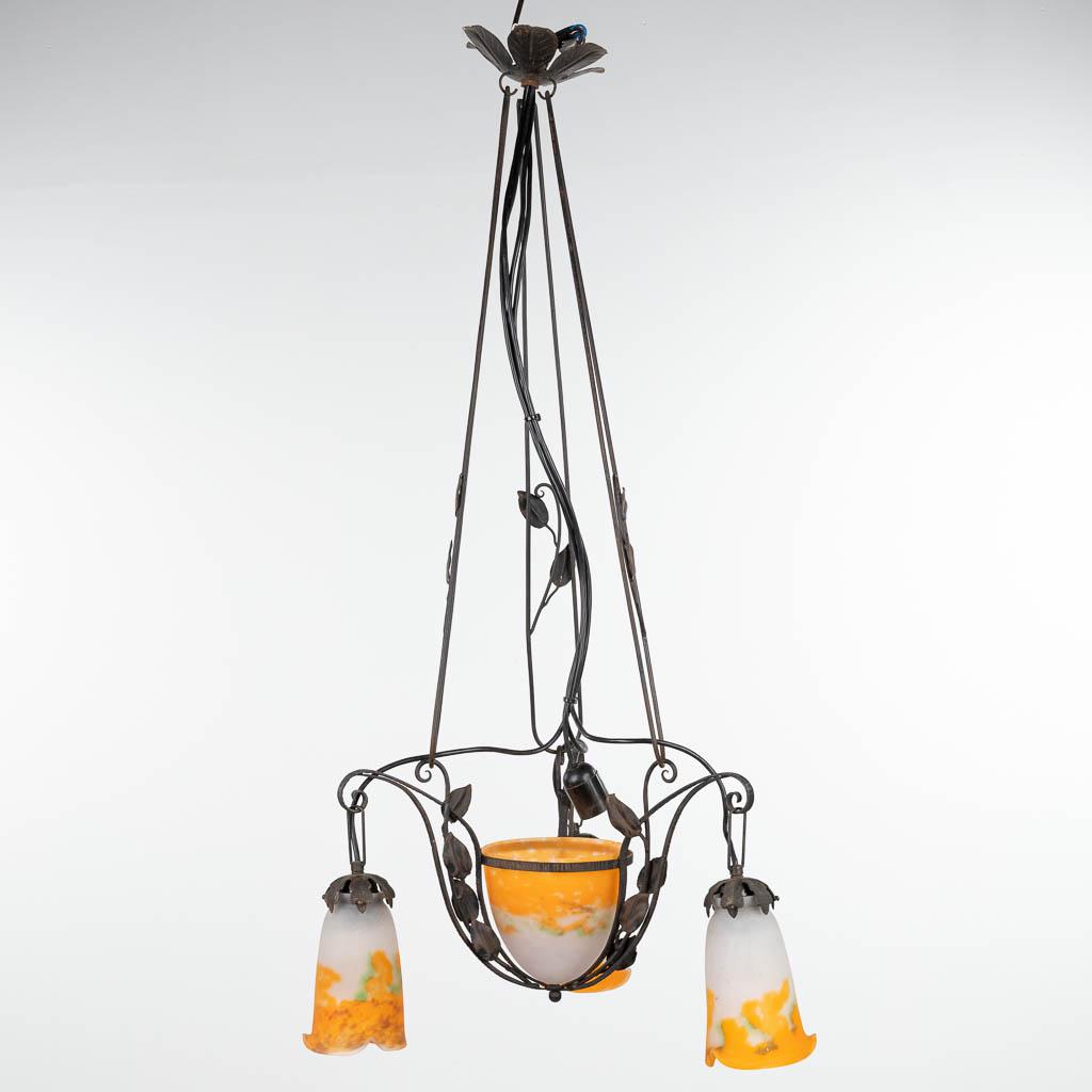 A chandelier in art deco style made of cast-iron and finished with pate-de-verre shades marked (1 of 19)