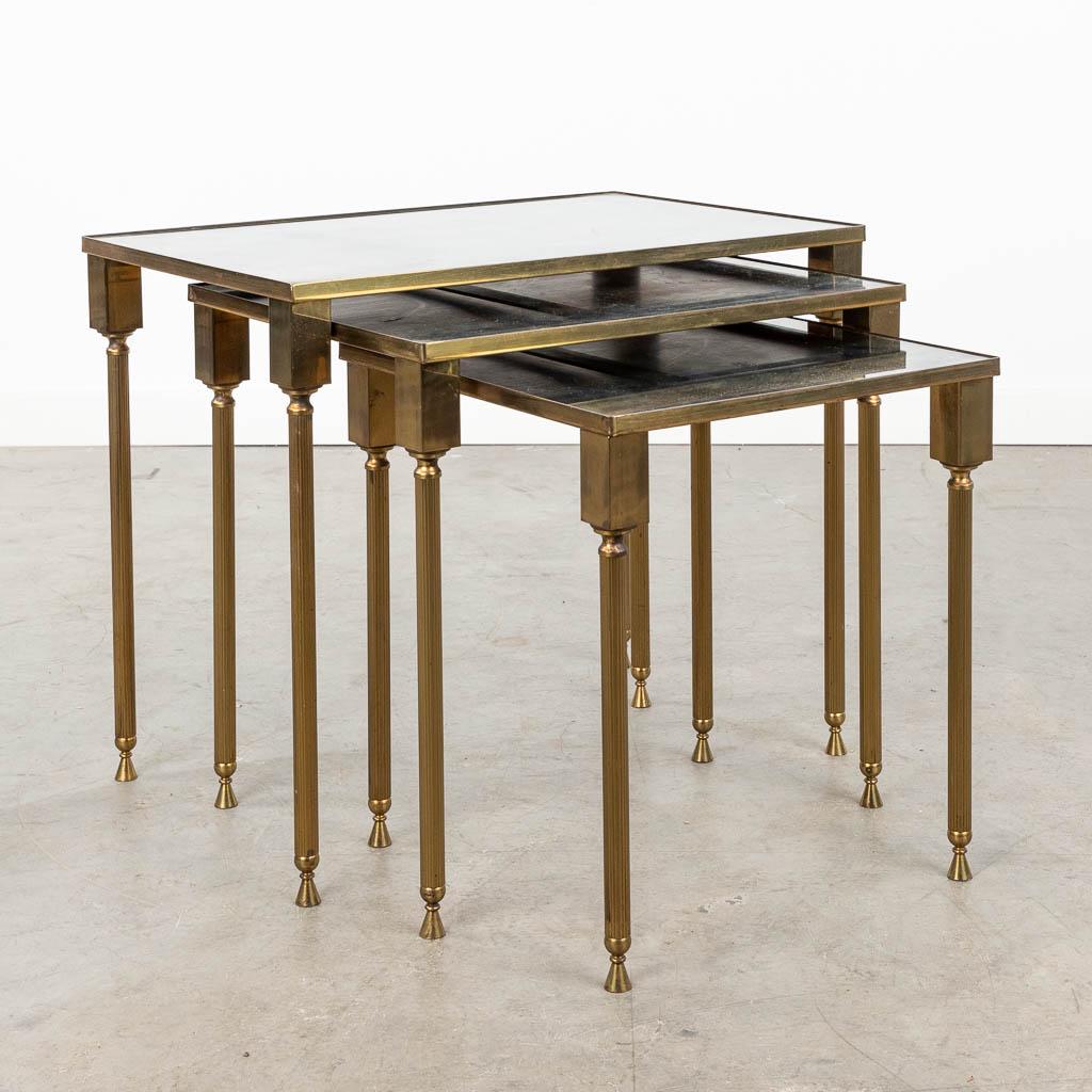 A set of 3 cigogne side tables with fumÃ© glass top, in the style of Maison Jansen. (L:32,5 x W:50: A set of 3 cigogne side tables with fumÃ© glass top, in the style of Maison Jansen.