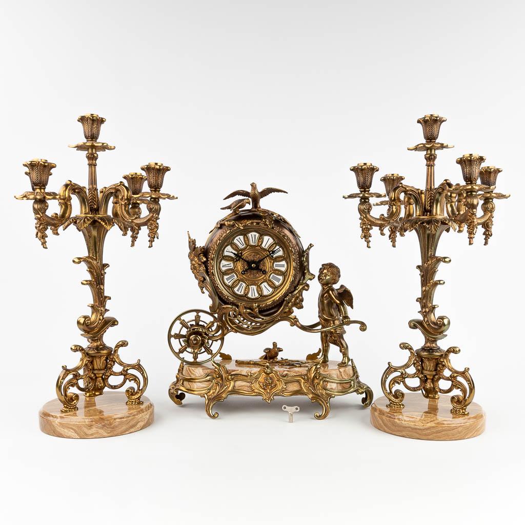 A three-piece mantle garniture clock and candelabra, made of bronze and onyx. 20th C. (L: 18 x W: 36 (1 of 19)