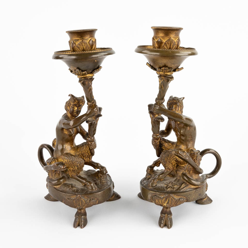 A pair of candlesticks with Satyr figurines, gilt bronze. 19th C. (D:7 x W:10 x H:17,5 cm): A pair of candlesticks with Satyr figurines, gilt bronze. 19th century . Dimensions: (D:7 x W:10 x H:17,5 cm)