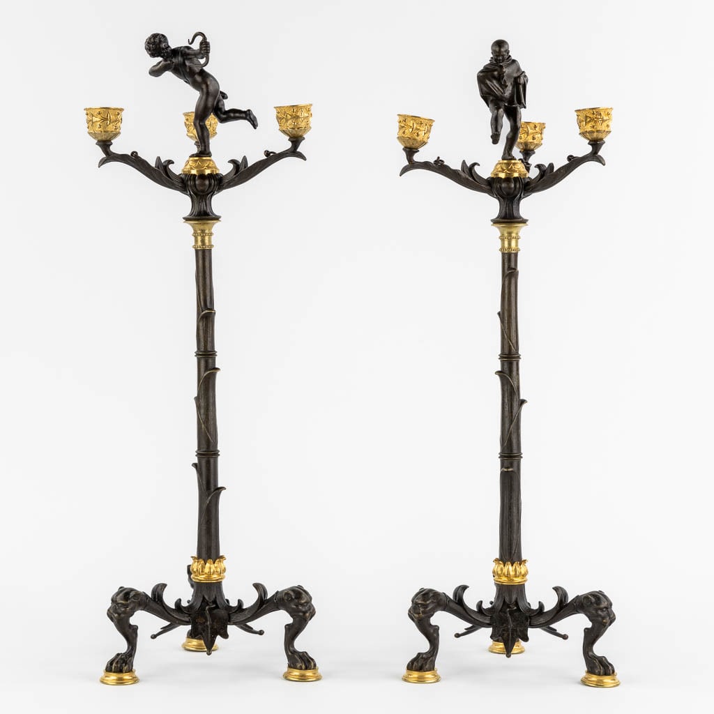 Auguste Maximilien DELAFONTAINE (1813-1892) A pair of candelabra, gilt and patinated bronze. (H:54 x: Auguste Maximilien DELAFONTAINE (1813-1892) A pair of candelabra, gilt and patinated bronze. Decorated with a Jester and an Amor/Cupid figurine. Signed on the base. Dimensions: (H:54 x D:17 cm)