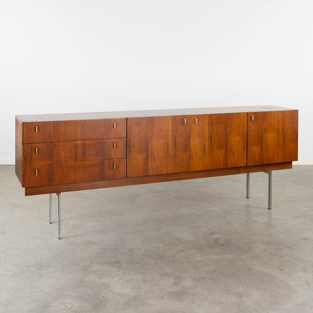 A mid-century sideboard, chromed metal and wood veneer. Probably Propos Meubelen, Hulmefa. (L:45 x: A mid-century sideboard, chromed metal and wood veneer. Probably Propos Meubelen, Hulmefa. Dimensions: (L:45 x W:233 x H:86 cm)