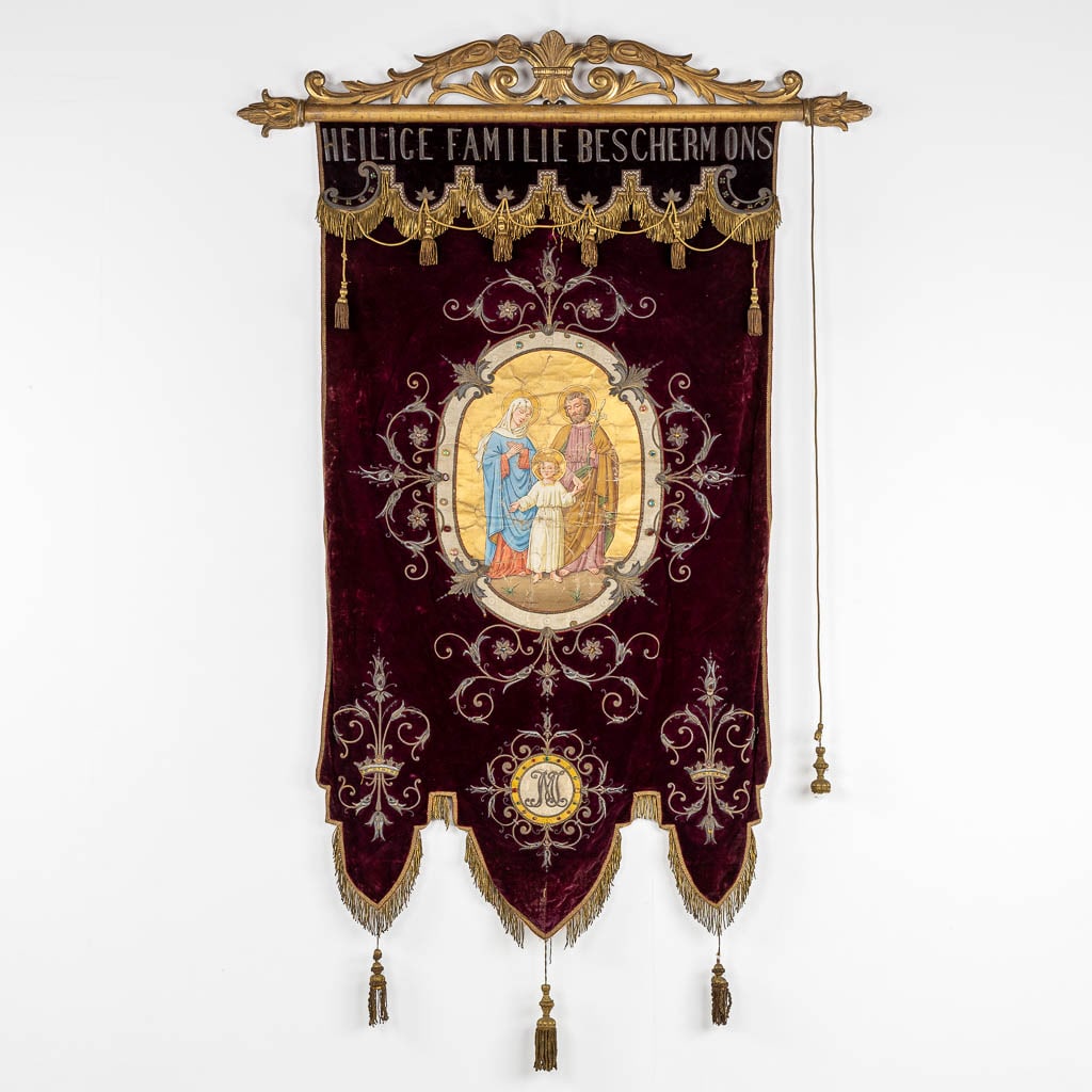 An antique banner with thick gold-thread embroideries and an image of 'The Holy Family'. (W:100 x: An antique banner with thick gold-thread embroideries and an image of 'The Holy Family'. On the top with an inscription 'Heiilige Familie Bescherm Ons' translated: 'Holy Family Pro