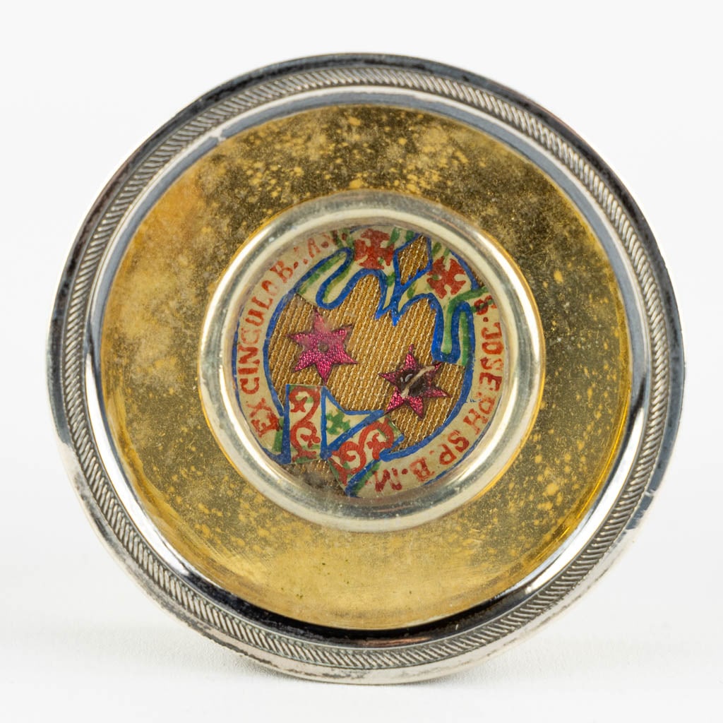 A brass with probably silver reliquary with a theca 'Ex Cingulo B.M.V. & S.Jospeh SP. B.M.V.'. (1 of 4)