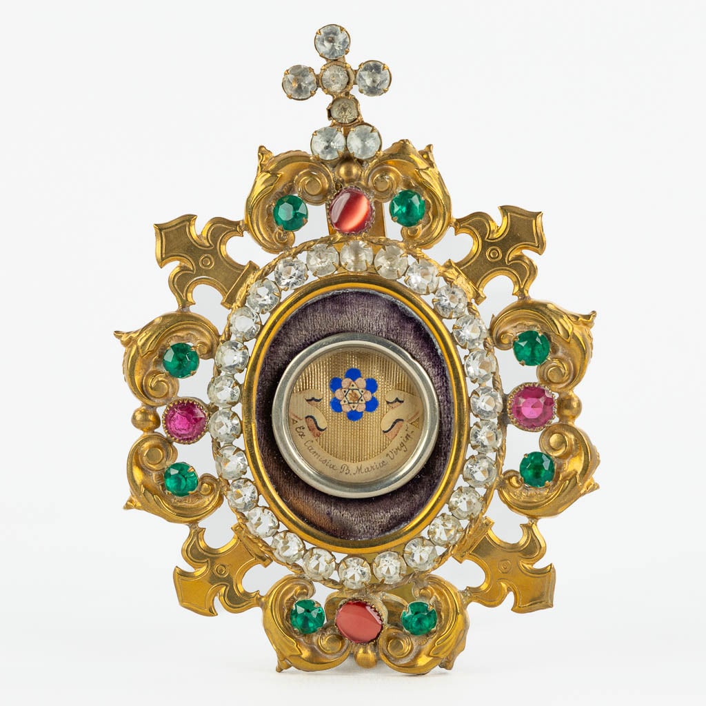 A sealed theca with a relic in a brass holder with glass cabochons, 'Ex Camisia Beata Maria (1 of 7)