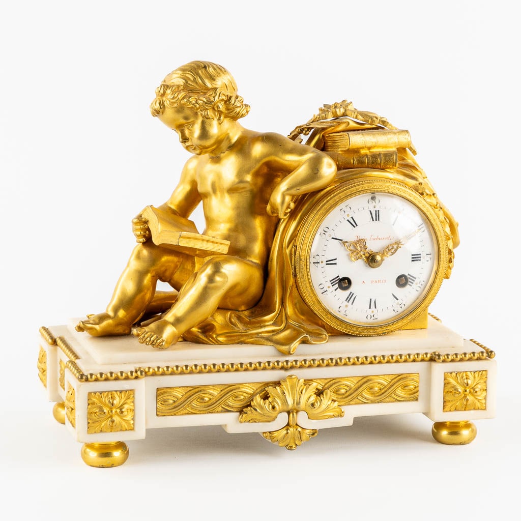 A mantle clock with a putti figurine, gilt bronze on white Carrara marble. 19th C. (L:15 x W:27 x (1 of 10)