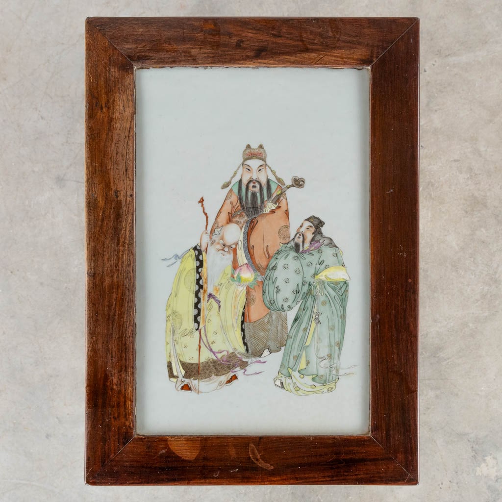 A Chinese side table with a porcelain plaque of Fu Lu and Shou. (L:34 x W:48 x H:80 cm): A Chinese side table with a porcelain plaque with a decor of Fu Lu and Shou. Dimensions: (L:34 x W:48 x H:80 cm)