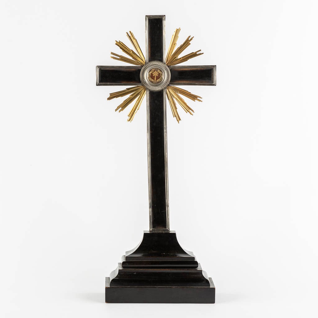 A crucifix with sunburst rays, mounted with a sealed theca and a relic of the True Cross. 19th C. (1 of 9)
