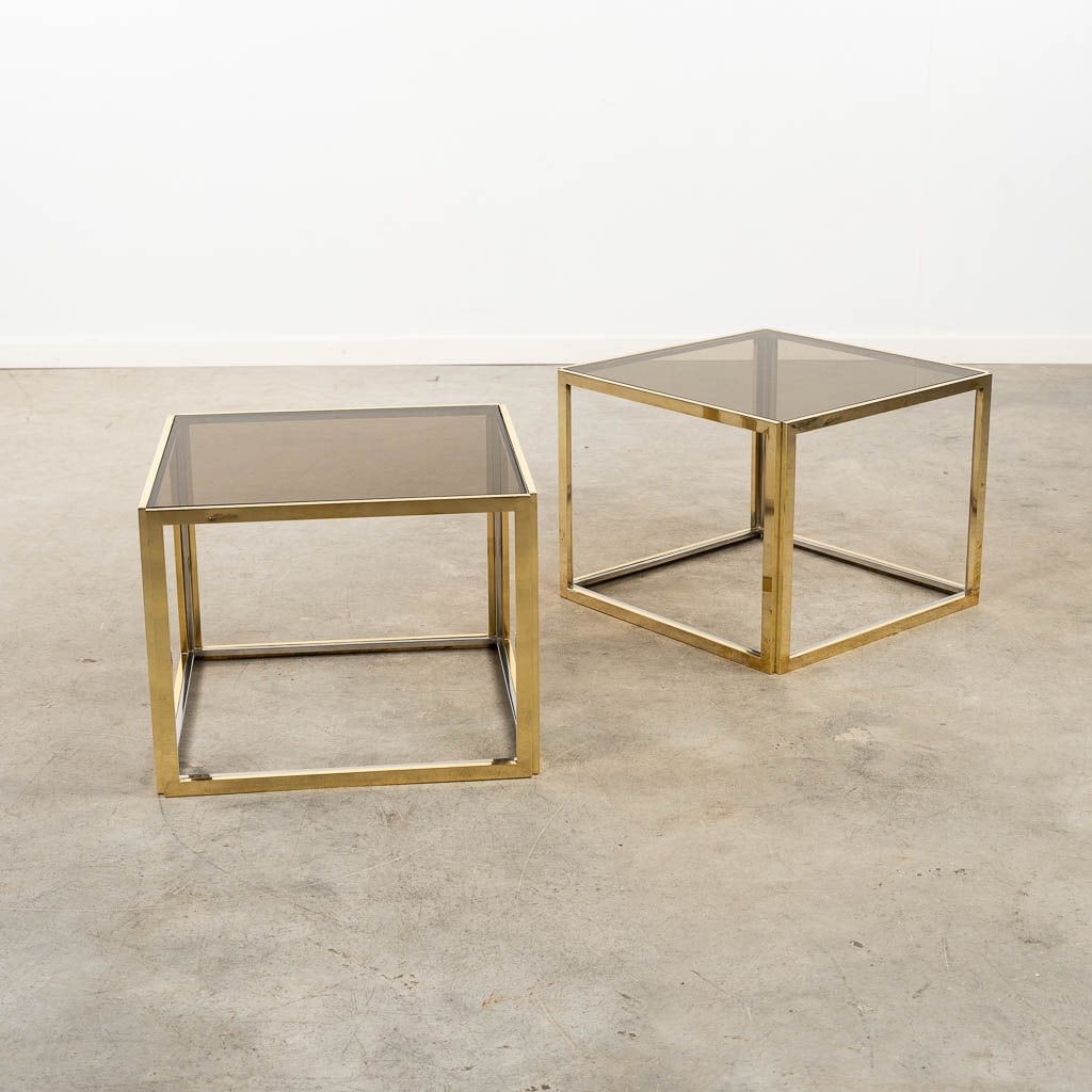 Maison Charles, a pair of occasional side tables, gilt brass and tinted glass. (L:49 x W:49 x H:38: Maison Charles, a pair of occasional side tables, gilt brass and tinted glass. Signed Jean Charles on the rim. Condition report: One glass top with a small chip in the corner. Dutch Description: