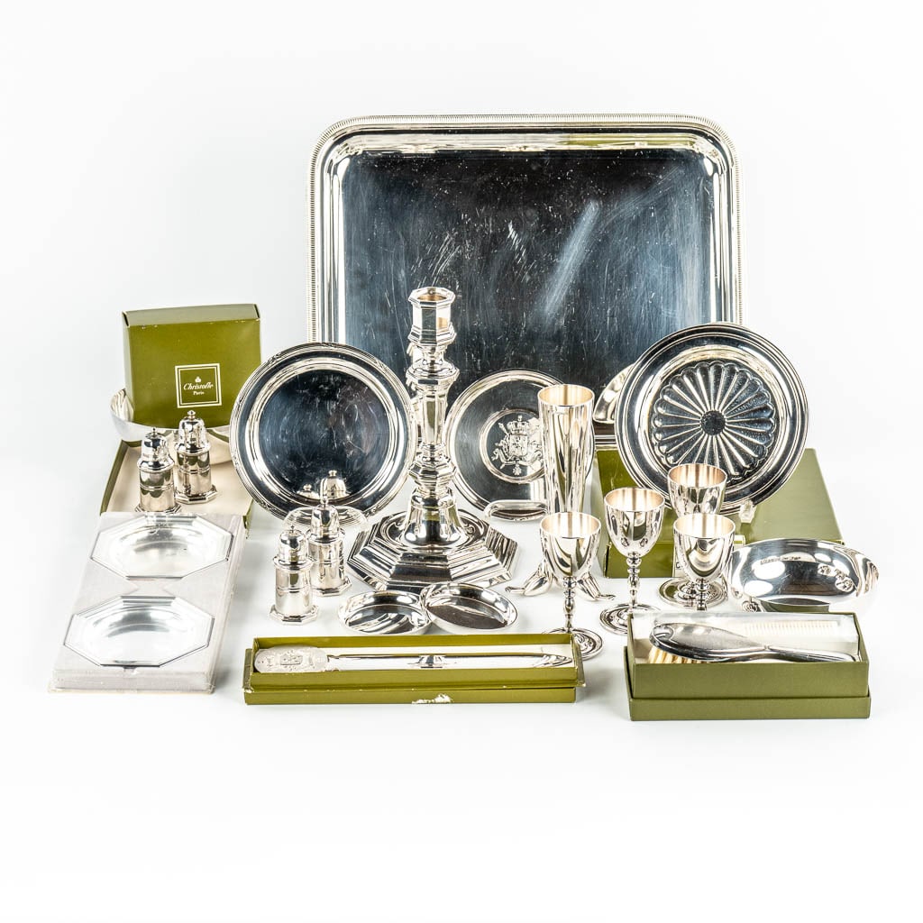 Christofle, a collection of table accessories and serving ware, silver plated metal. (L:29 x W:35,5: Christofle, a collection of table accessories and serving ware, silver plated metal. Letter opener, pepper and salt jars, hair brush, wine bottle coasters, a candlestick. The lot is mostly in new cond