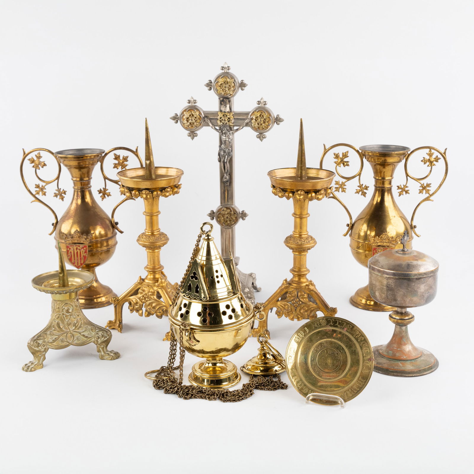 A collection of nine pieces of liturgical vasa sacra and candlesticks, bronze and brass. (1 of 9)