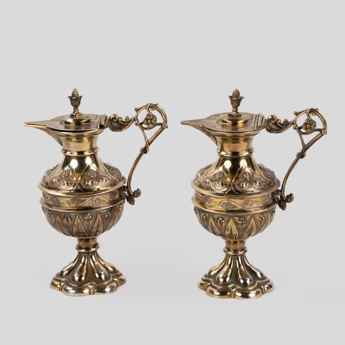 A pair of vermeil silver wine and water cruets, Gothic Revival. 270g.: A pair of vermeil silver wine and water cruets, Gothic Revival. French Export silver mark, 'Head Of Mercury', 1st grade silver