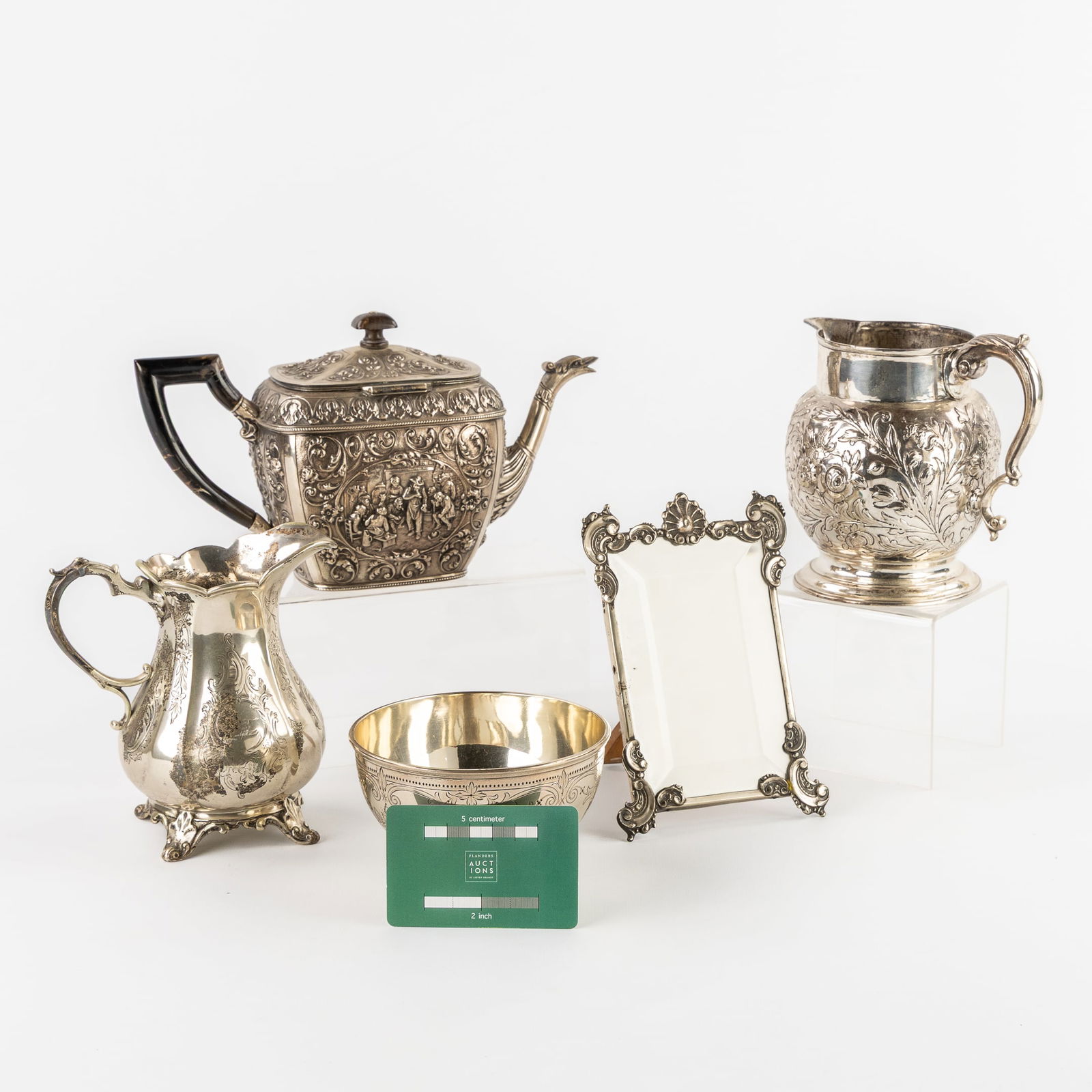 A Collection of Silver Table Accessories, England, the Netherlands and Portugal. Silver, 1,225kg: A Collection of Silver Table Accessories, England, the Netherlands and Portugal. Silver. Teapot, decorated with animated scenes and a griffin as a pouring spout.Regional assay office mark: Helmeted ma