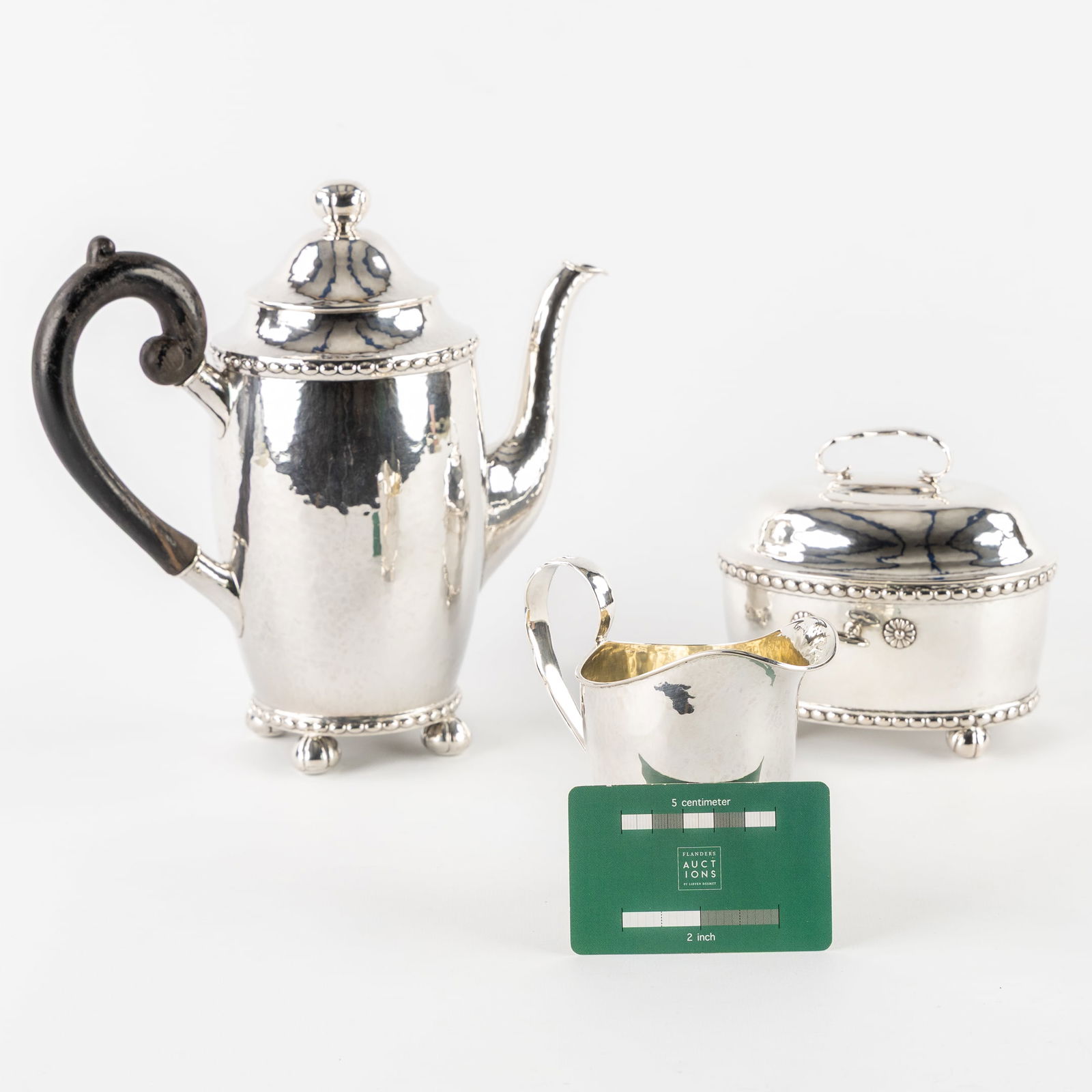 C.G. Hallberg, Stockholm, 1920, a Three-piece Coffee Set. Sweden. Silver, 1,161kg: C.G. Hallberg, Stockholm, 1920, a Three-piece Coffee Set. Sweden. Silver. A three-piece silver coffee set.Coffee pot with ebonised wooden handle. H: 22 cm.Sugar bowl with lock and key. H: 12 cm.