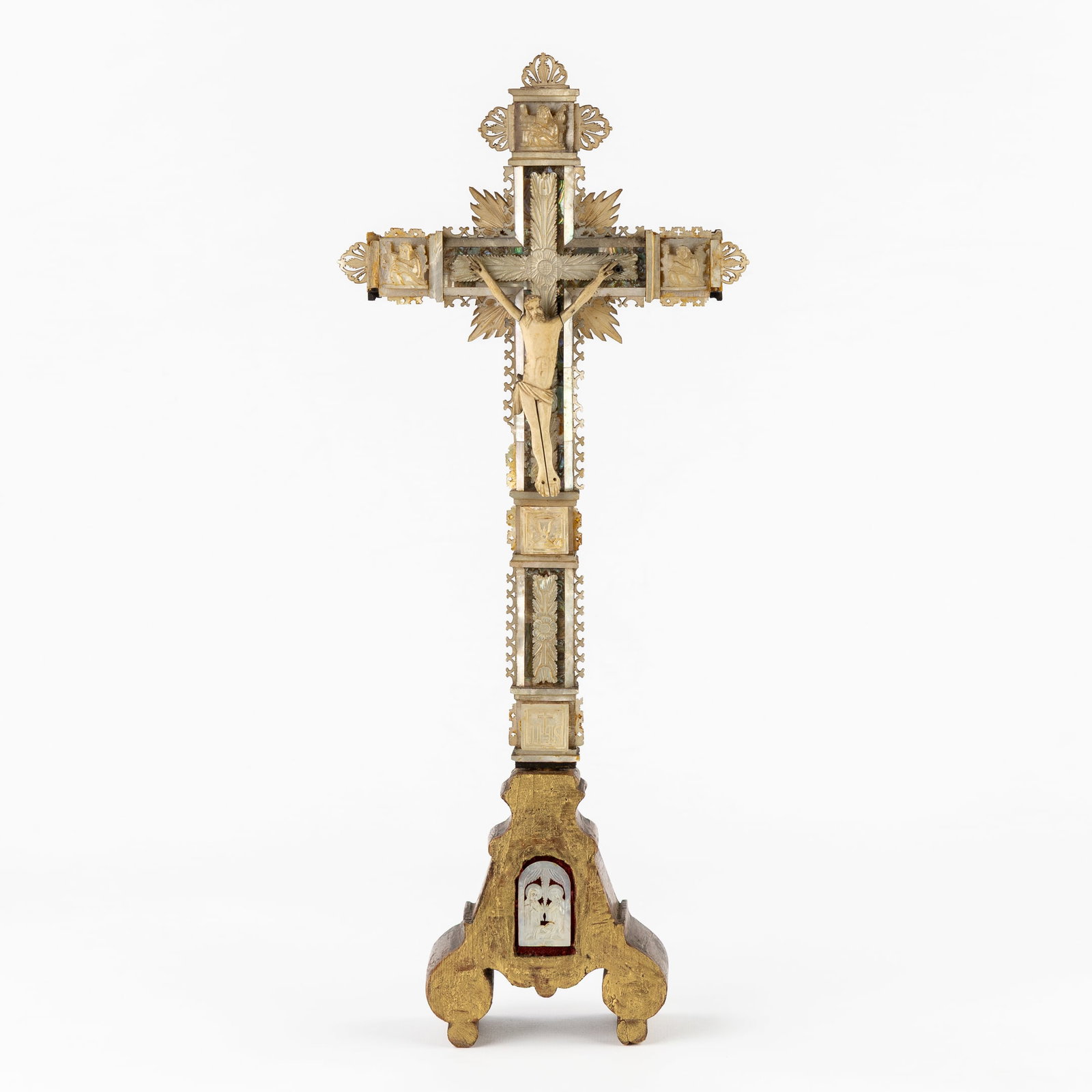 A Wooden Reliquary Cross, mounted with a Corpus Christi and decorated with Mother of Pearl. Circa: A Wooden Reliquary Cross, mounted with a Corpus Christi and decorated with Mother of Pearl. Circa 1900. Reliquary cross.Mounted with a Corpus Christi (bone).Decorated with mother of pearl plaques (I