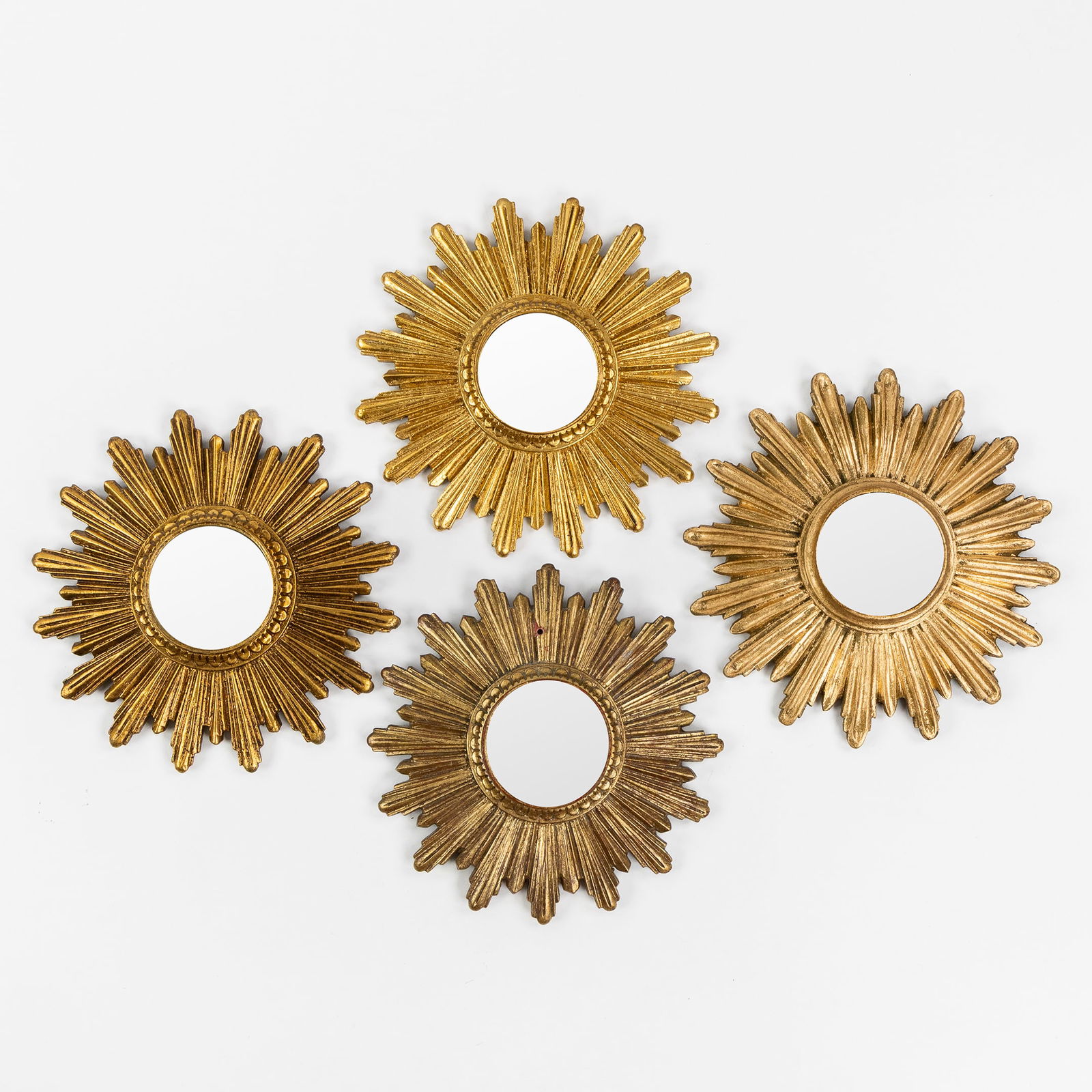 Four mid-century sunburst mirrors, convex glass. Circa 1970.: Four mid-century sunburst mirrors, convex glass. Circa 1970.