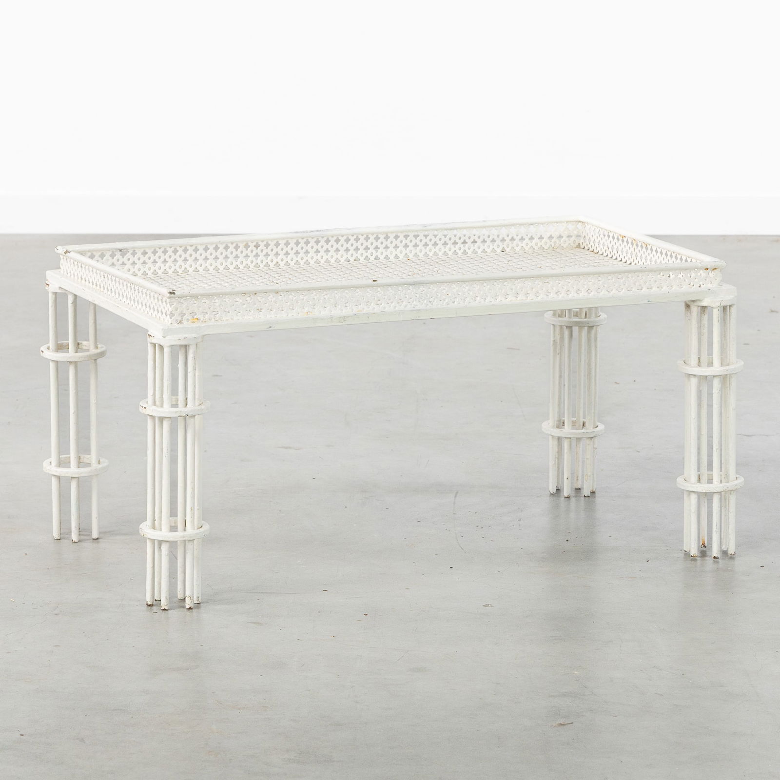 Mathieu Matégot (1910-2001) A Low Side Table or Coffee Table, Patinated Metal. France, circa 1950.: Mathieu Matégot (1910-2001) A Low Side Table or Coffee Table, Patinated Metal. France, circa 1950. White patinated wrought iron and perforated steel plate with shamrock motifs.Not signed.France, cir