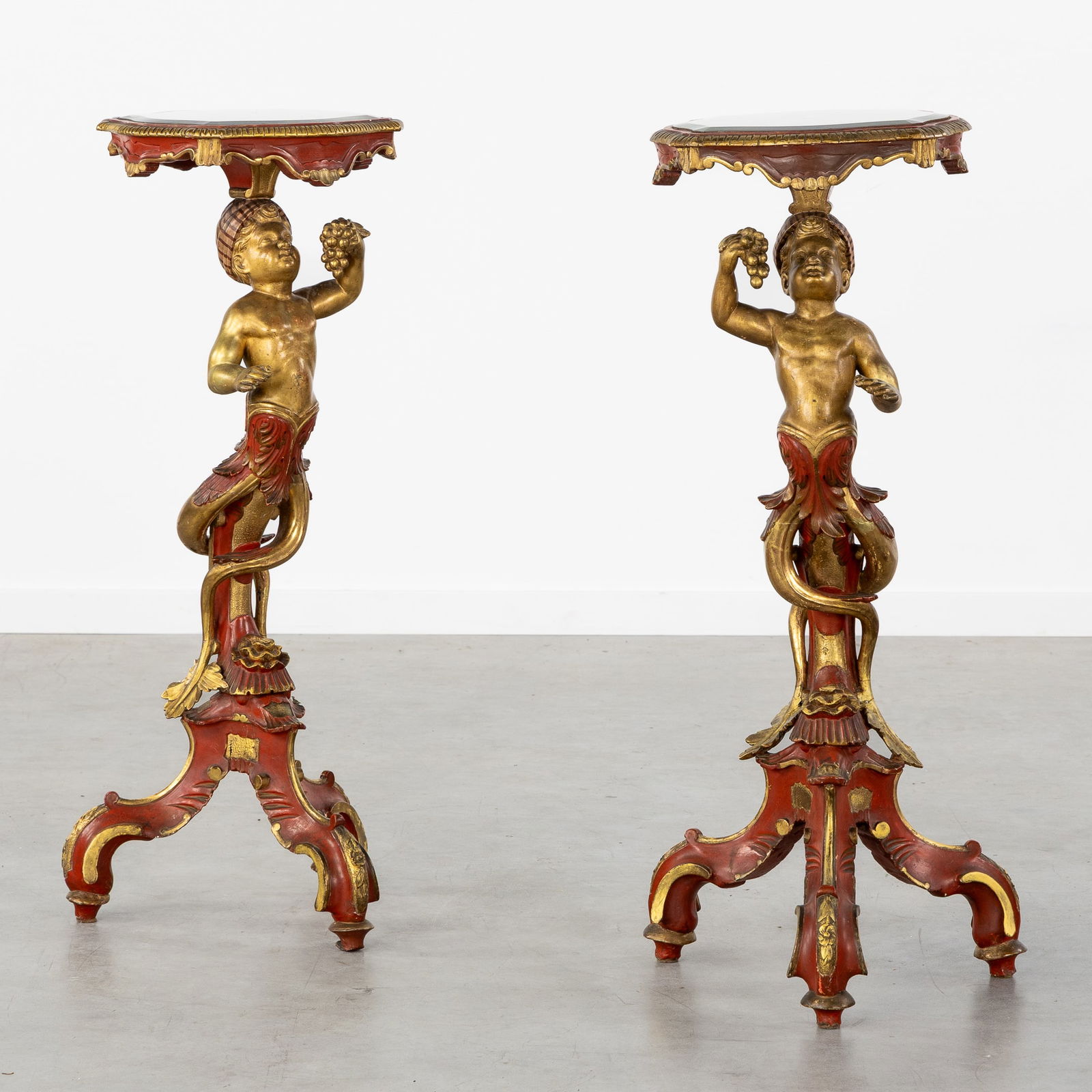 A Pair of Venetian Console Tables or Pedestals, Patinated and Gilded Wood, Putti with Grapes,: A Pair of Venetian Console Tables or Pedestals, Patinated and Gilded Wood, Putti with Grapes, 19th/20th century. Sculptured, gilded, and patinated wood.Finished with a facet-cut mirror.Decorated wit