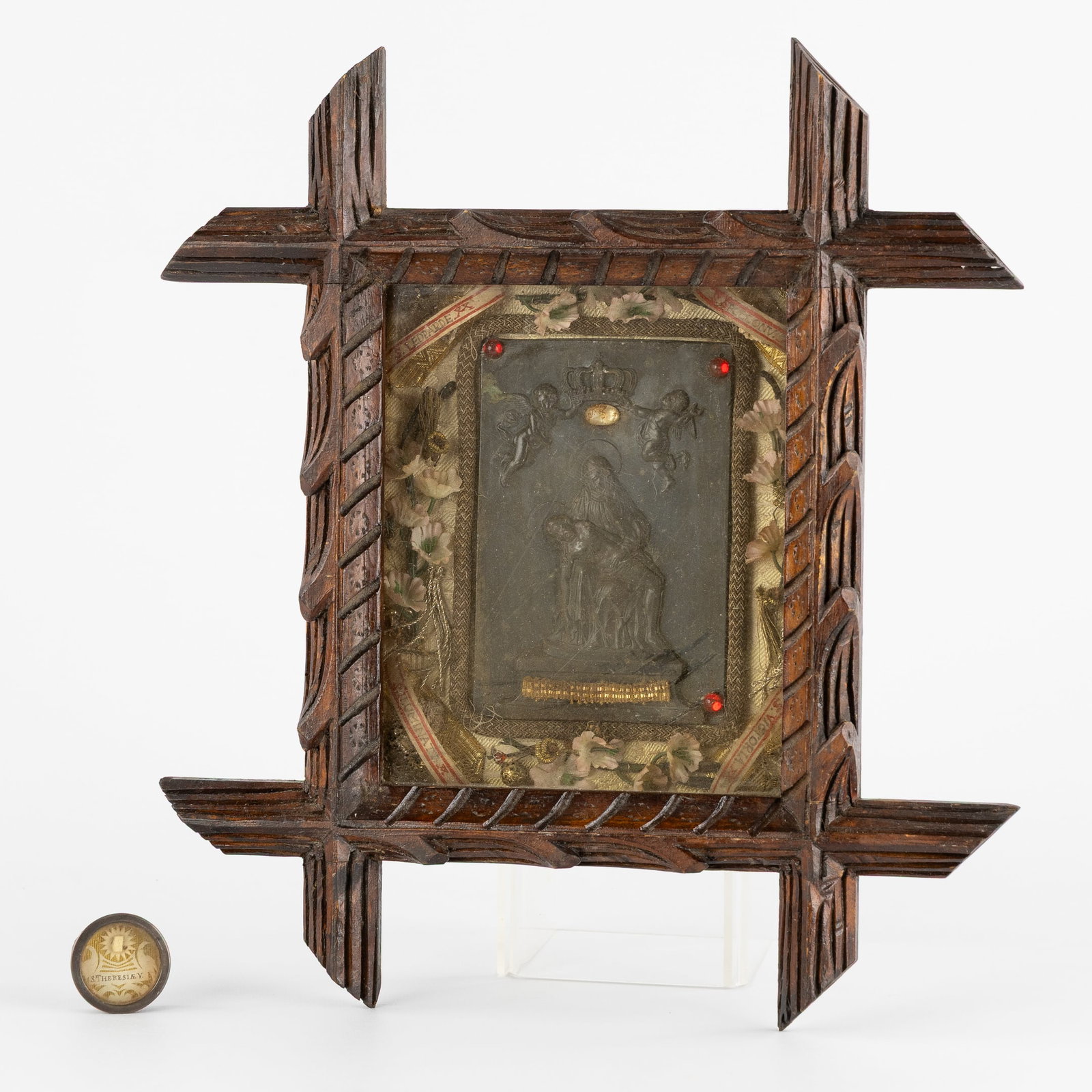 A Reliquary frame with Four Relics, Pieta Bas-Relief, and a Theca with a Relic of Saint Therese.: A Reliquary frame with Four Relics, Pieta Bas-Relief, and a Theca with a Relic of Saint Therese. A wood-sculptured reliquary frame, decorated with a Pieta bas-relief and relics for: Saint Leopard Mart