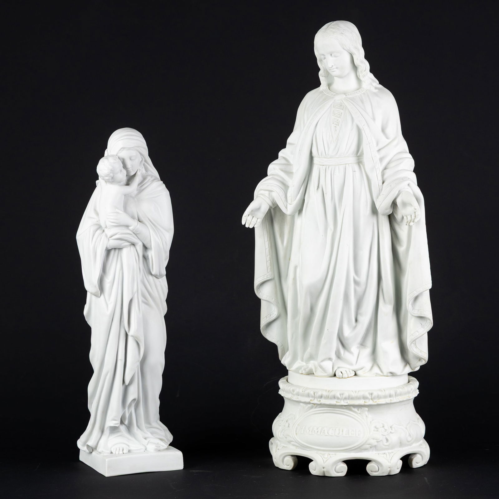 The Immaculate Mary and Madonna and Child, two biscuit porcelain statues.: The Immaculate Mary and Madonna and Child, two biscuit porcelain statues. Biscuit porcelain. The Immaculate Virgin Mary, on a biscuit base with the inscription "L'Immaculée" (Height of the statue: 45