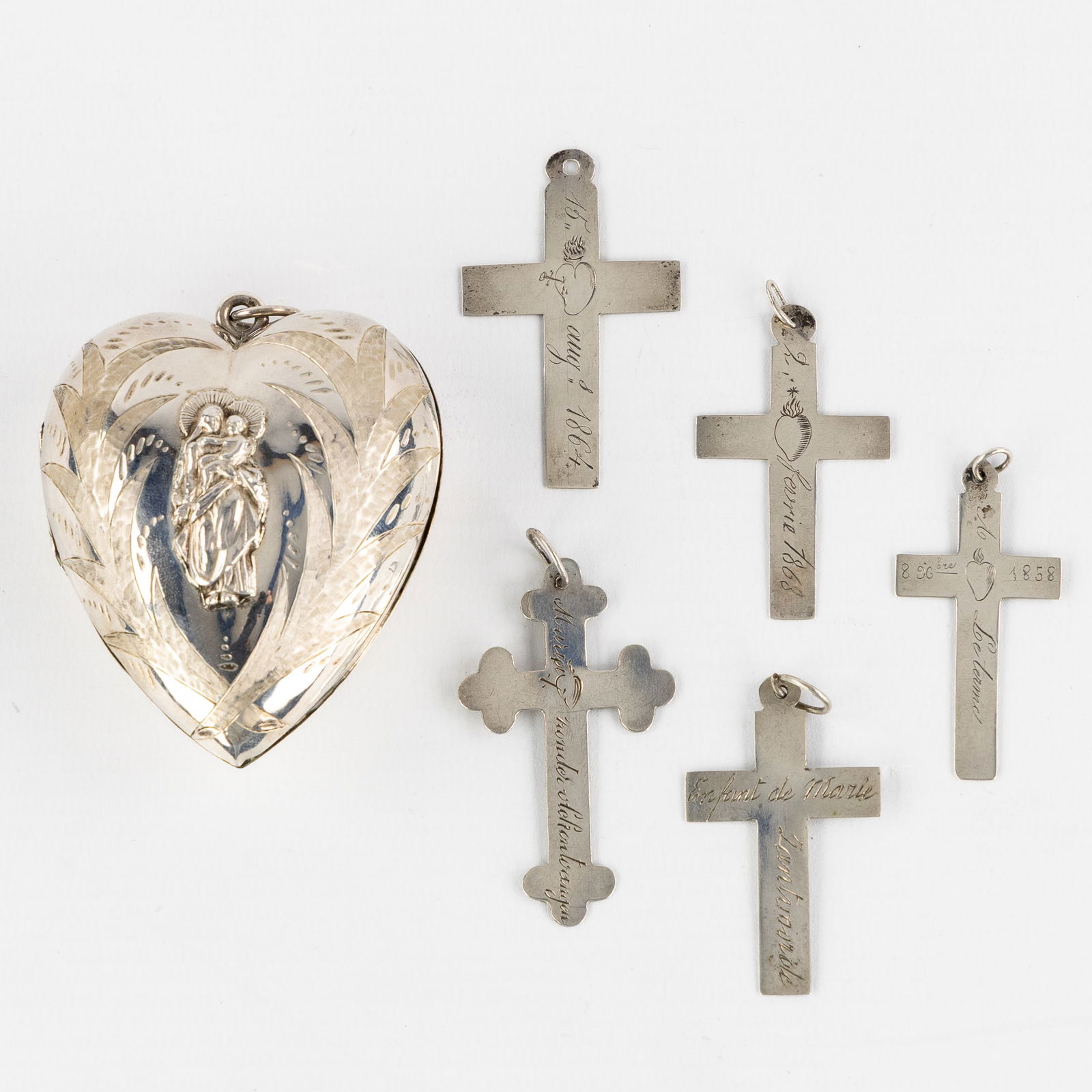 A Silver Sacred Heart, Ex Voto, added five Silver Crucifix Pendants, 19th C. Silver, 44g. (1 of 6)