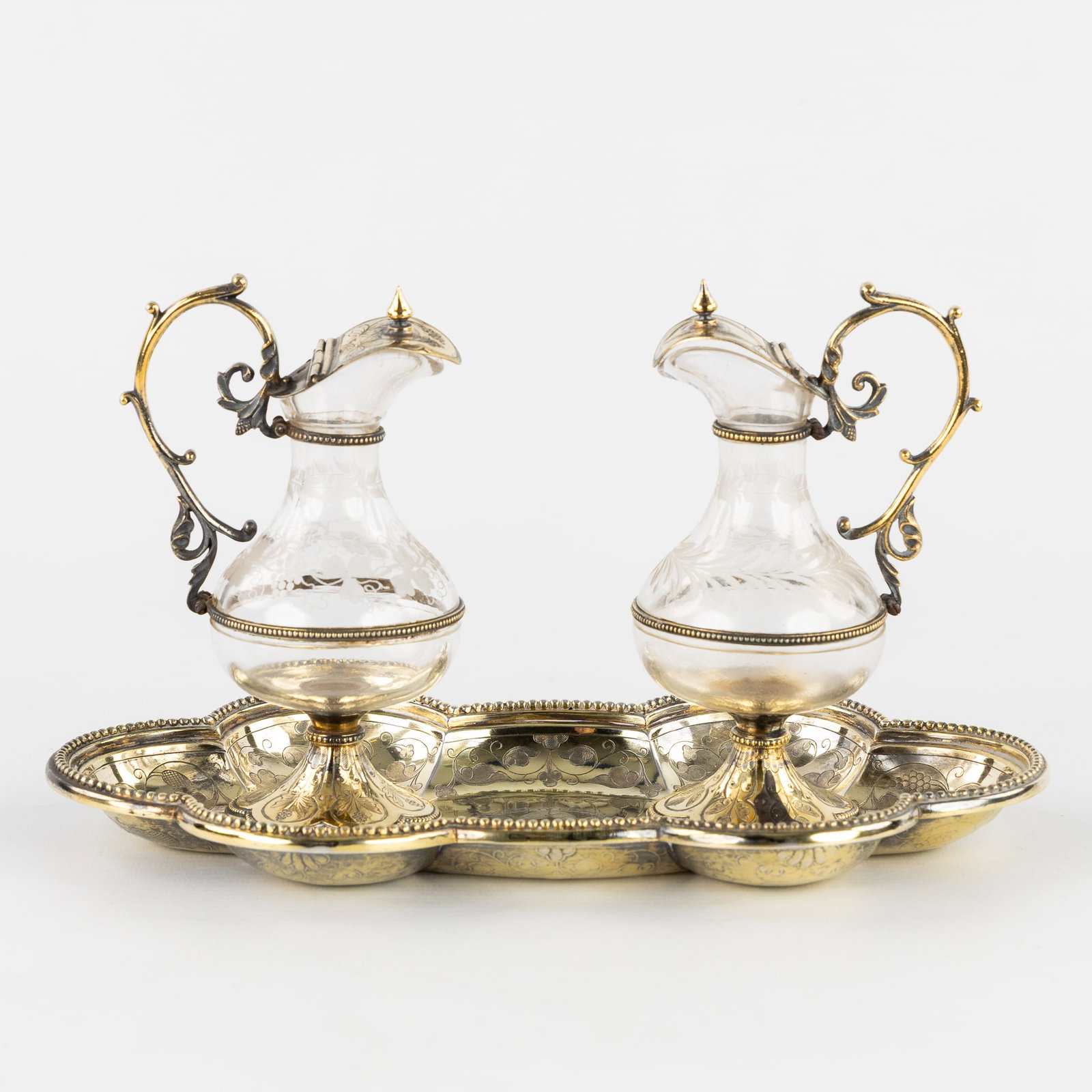 French School, a pair of vermeil wine and water cruets, silver and crystal. 19th C.: French School, a pair of vermeil wine and water cruets, silver and crystal. 19th century. Gilt silver/vermeil.