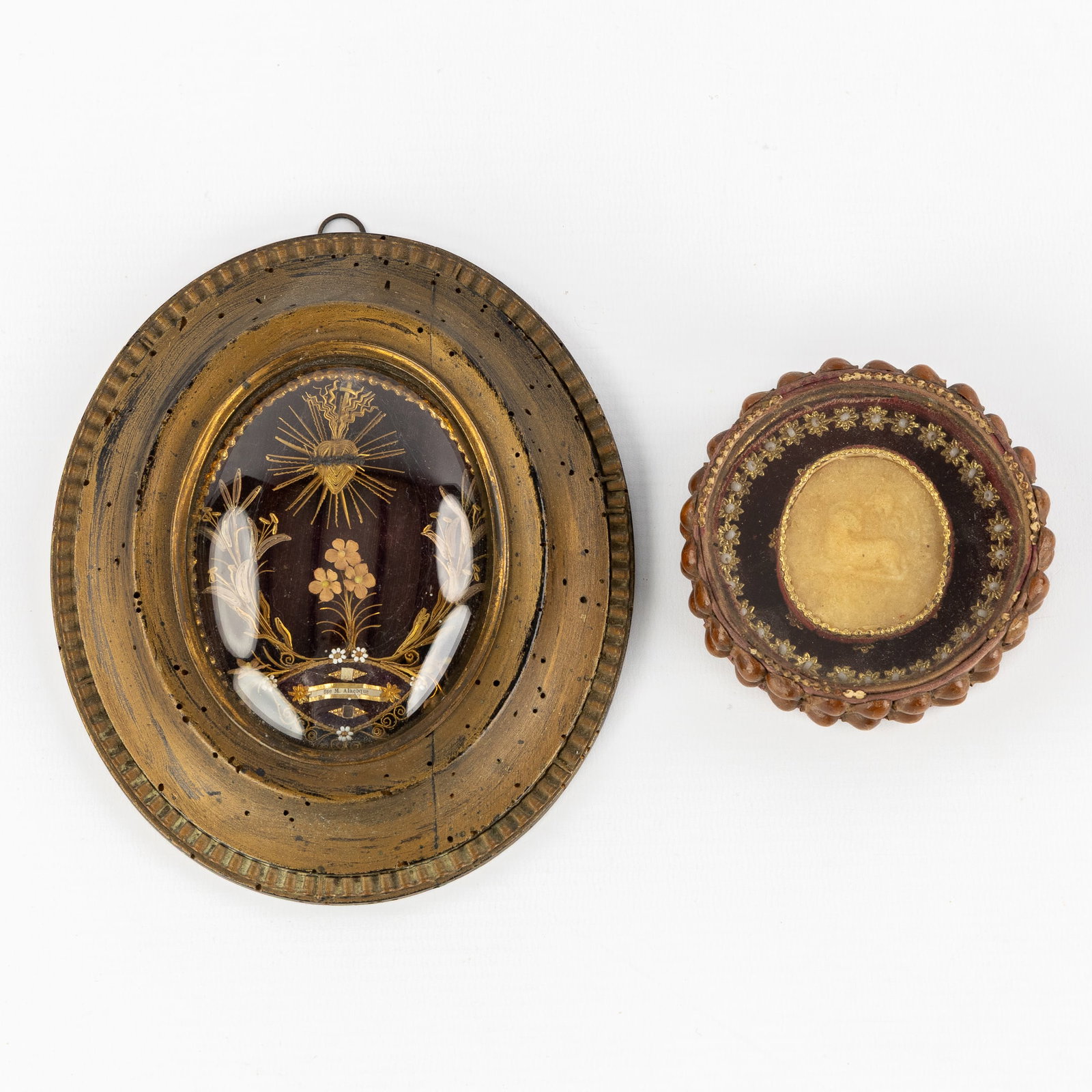 Two reliquary Frames with Relics for the Blessed Margaret Mary Alacoque and Agnus Dei (Lamb of God).: Two reliquary Frames with Relics for the Blessed Margaret Mary Alacoque and Agnus Dei (Lamb of God). Oval reliquary frame with a relic for Blessed Margaret Mary Alacoque. Decorated with floral filigre