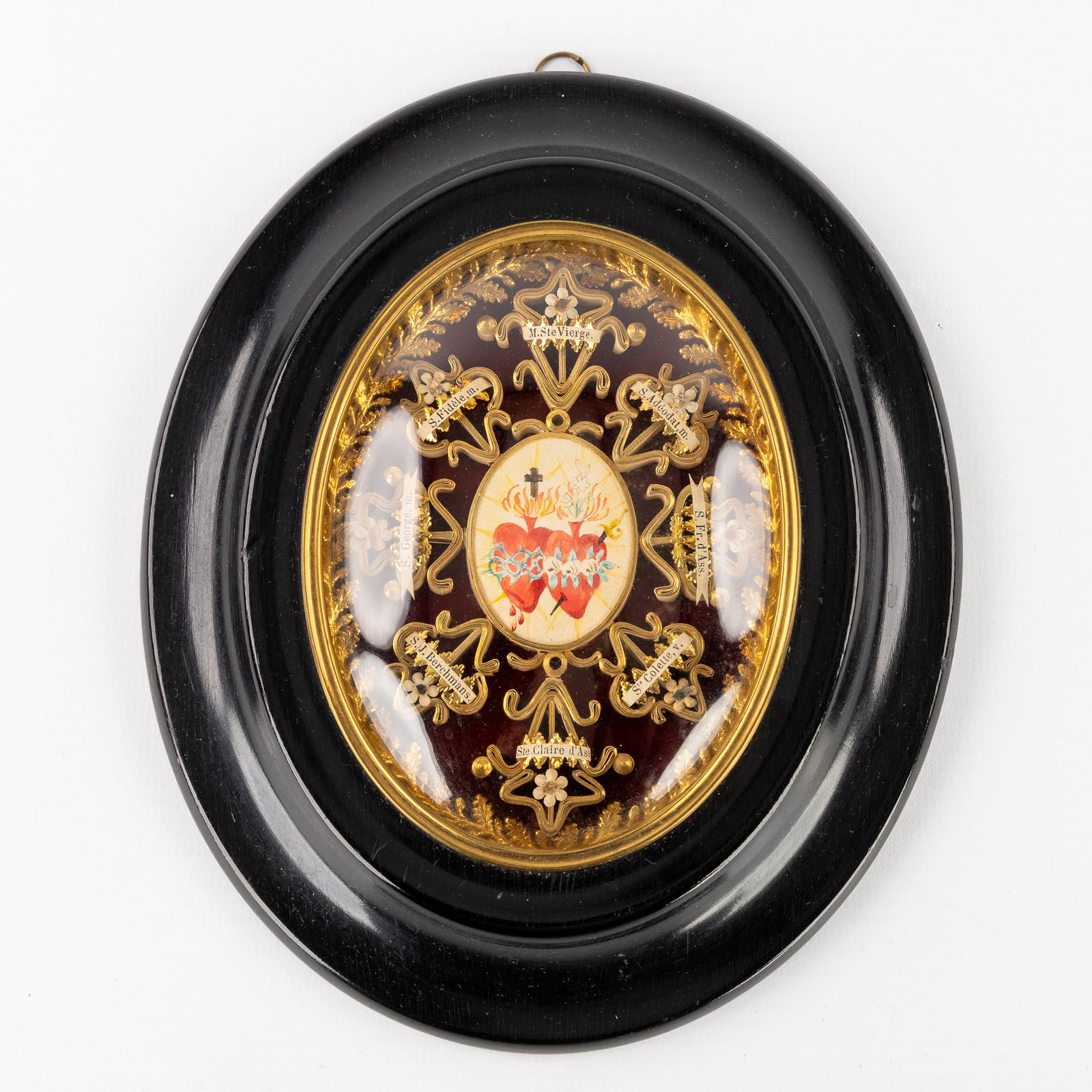 An Oval Reliquary Frame with Eight Relics for Saints and Martyrs, with a miniature painting of the (1 of 3)