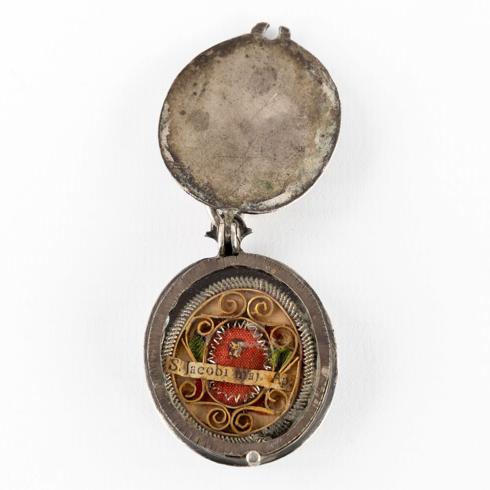 An antique reliquary pendant featuring a relic of Saint James the Greater, Apostle. Silver. 18th C (1 of 3)