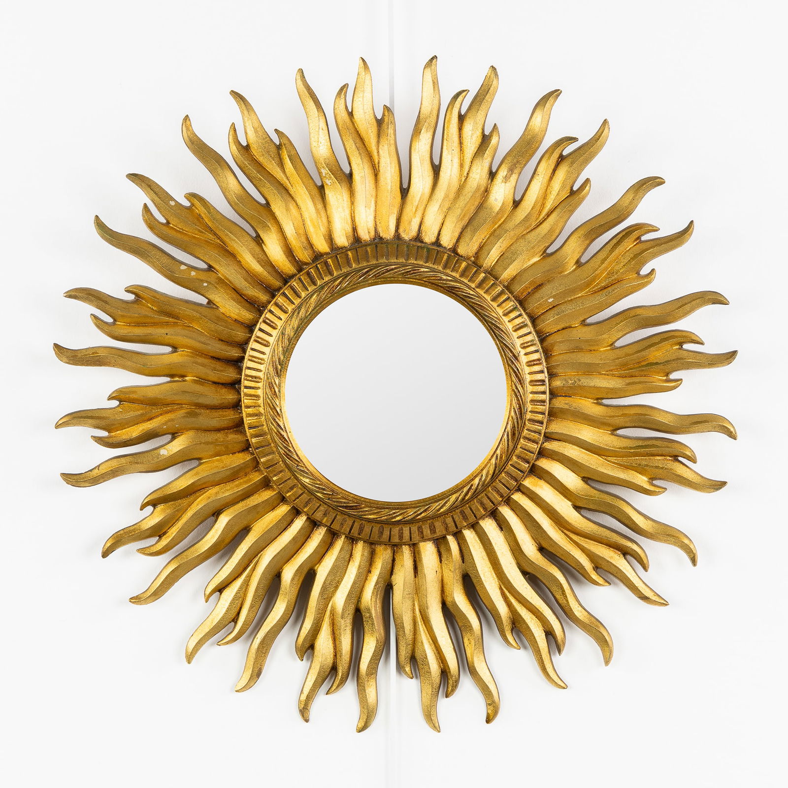 A Mid-Century Sunburst Mirror, Gilded, Convex Glass. Circa 1970.: A Mid-Century Sunburst Mirror, Gilded, Convex Glass. Circa 1970. Convex glass.Gilded resin.Circa 1970.