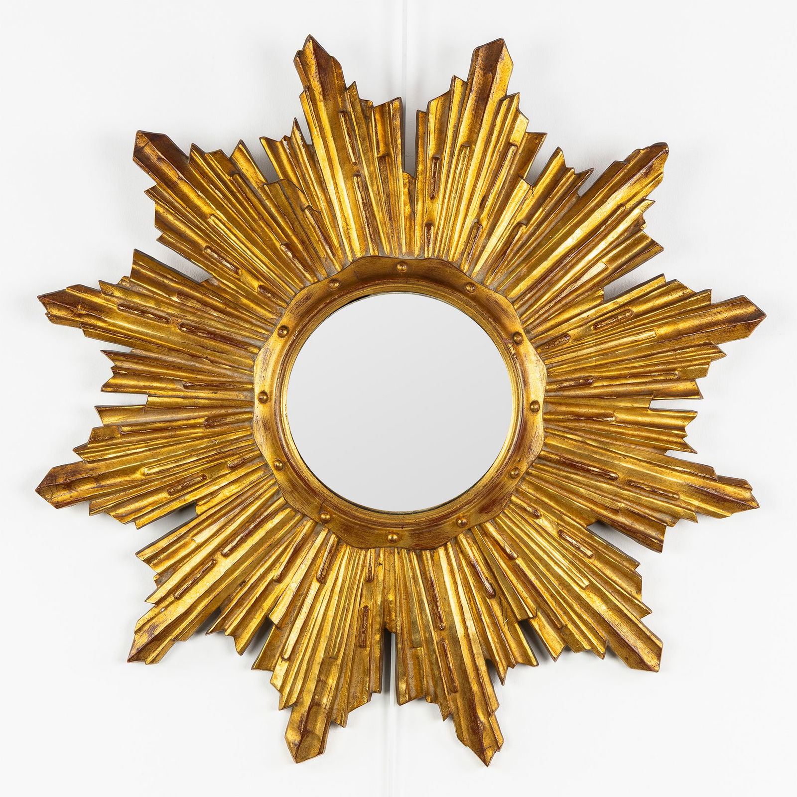 A Mid-Century Sunburst Mirror, Gilded, Convex Glass. Circa 1970.: A Mid-Century Sunburst Mirror, Gilded, Convex Glass. Circa 1970. Convex glass.Gilded resin.Circa 1970.