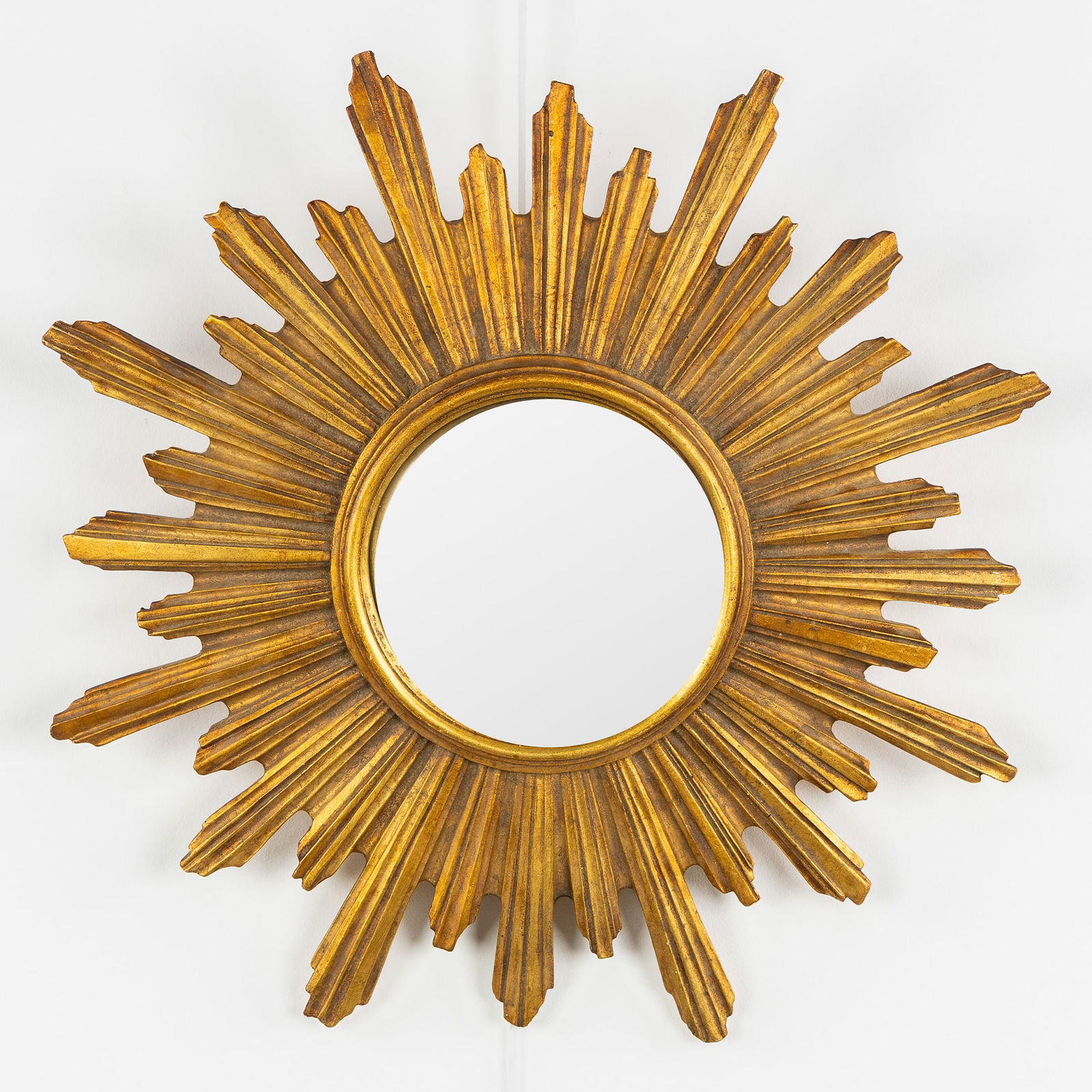 A Mid-Century Sunburst Mirror, Gilded, Convex Glass. Circa 1970.: A Mid-Century Sunburst Mirror, Gilded, Convex Glass. Circa 1970. Convex glass.Gilded resin.Circa 1970.