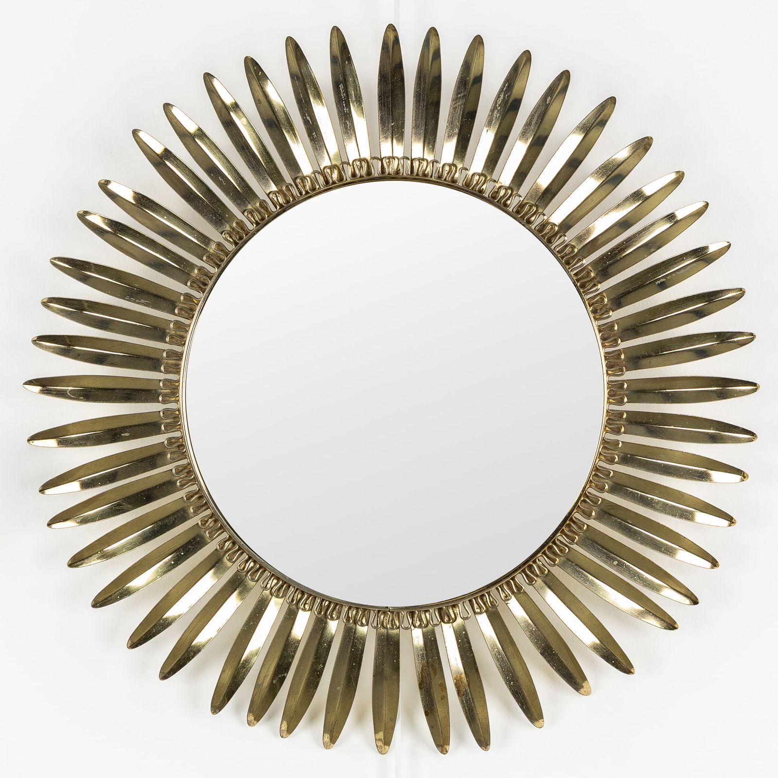 A Mid-Century Sunburst Mirror, Gilded Brass, Convex Glass. Circa 1970.: A Mid-Century Sunburst Mirror, Gilded Brass, Convex Glass. Circa 1970. Convex glass.Gilded brass.Circa 1970.