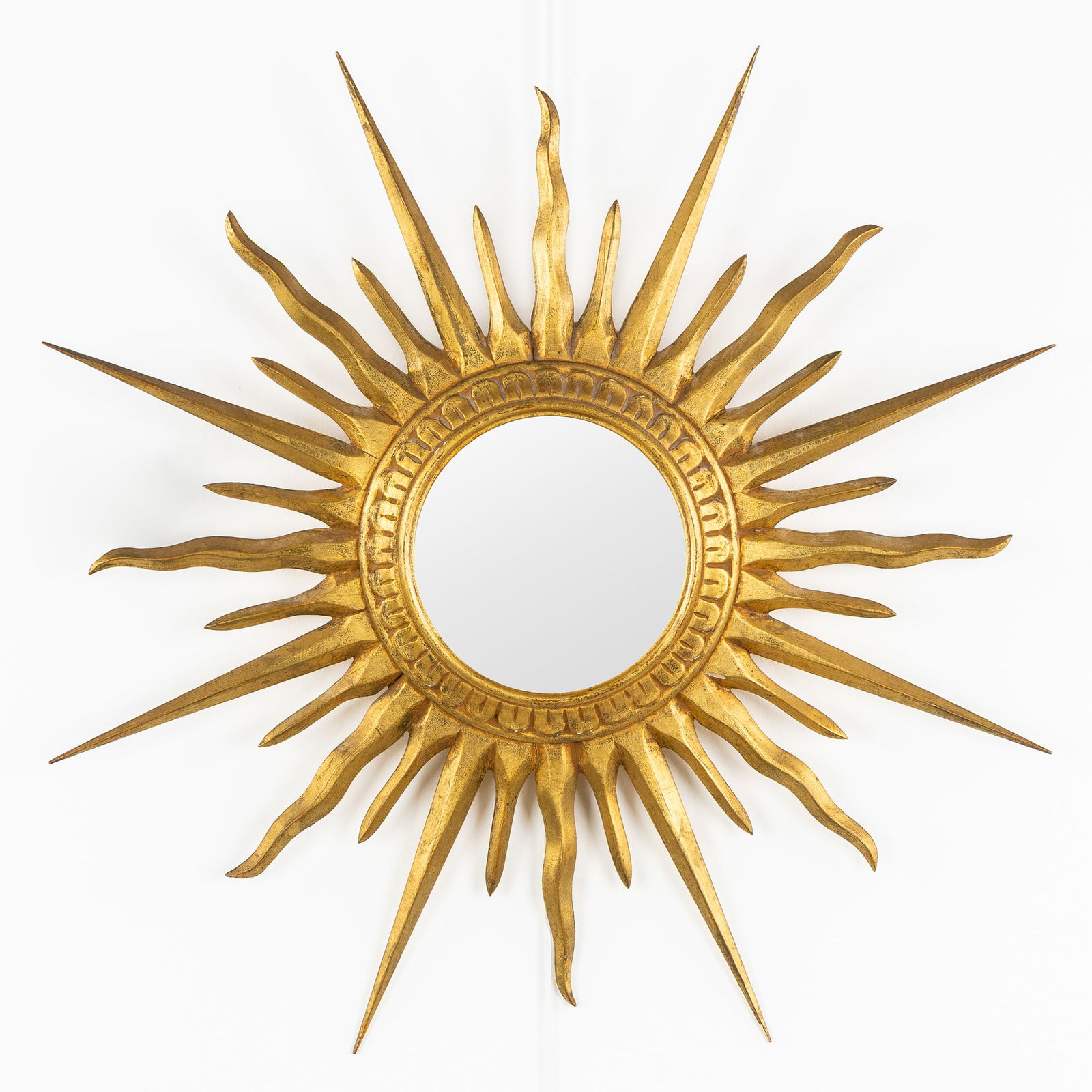 A Mid-Century Sunburst Mirror, Gilded, Wood-Sculptured, Convex Glass. Circa 1970.: A Mid-Century Sunburst Mirror, Gilded, Wood-Sculptured, Convex Glass. Circa 1970. Convex glass.Gilded wood.Circa 1970.