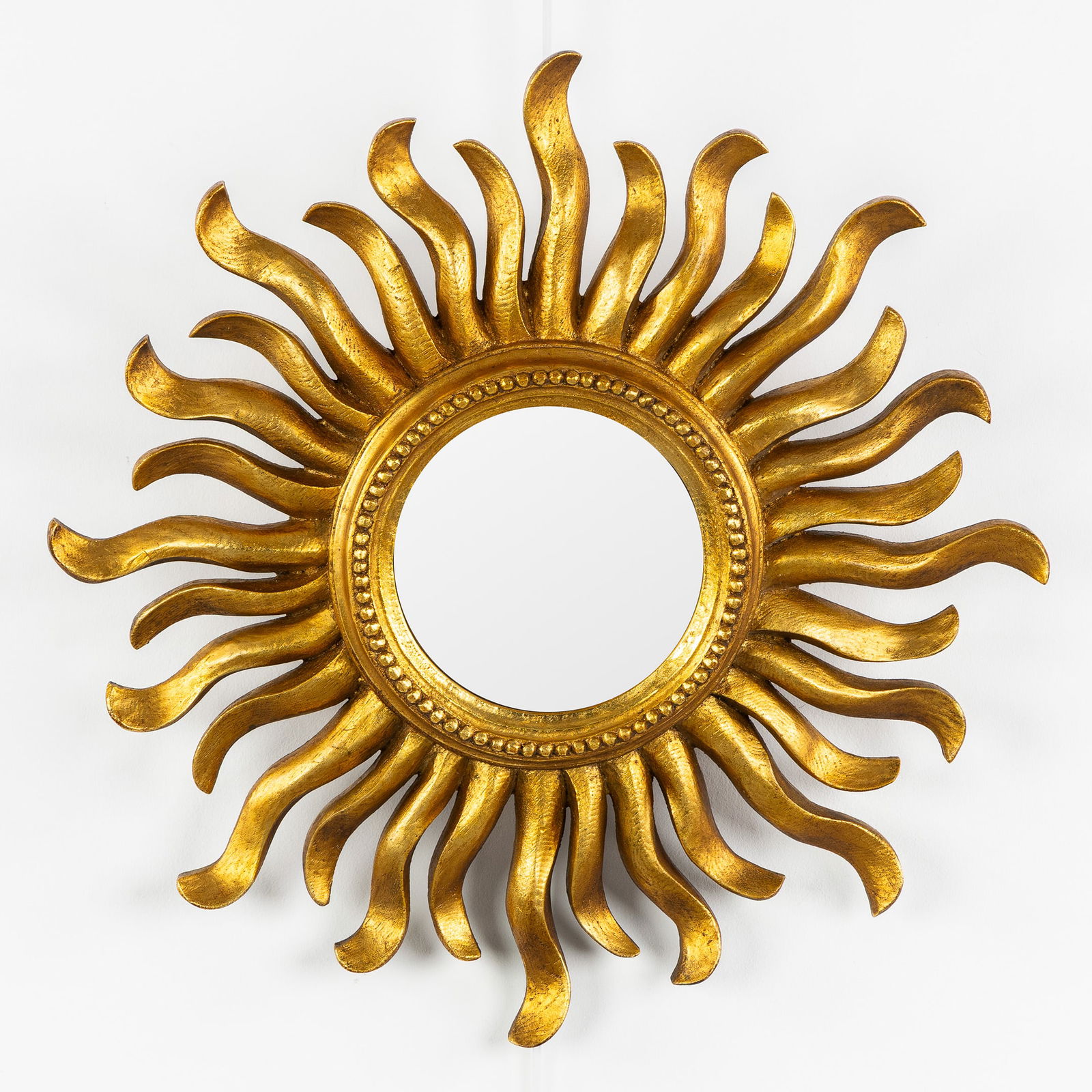 A Mid-Century Sunburst Mirror, Gilded, Convex Glass. Circa 1970.: A Mid-Century Sunburst Mirror, Gilded, Convex Glass. Circa 1970. Convex glass.Gilded resin.Circa 1970.