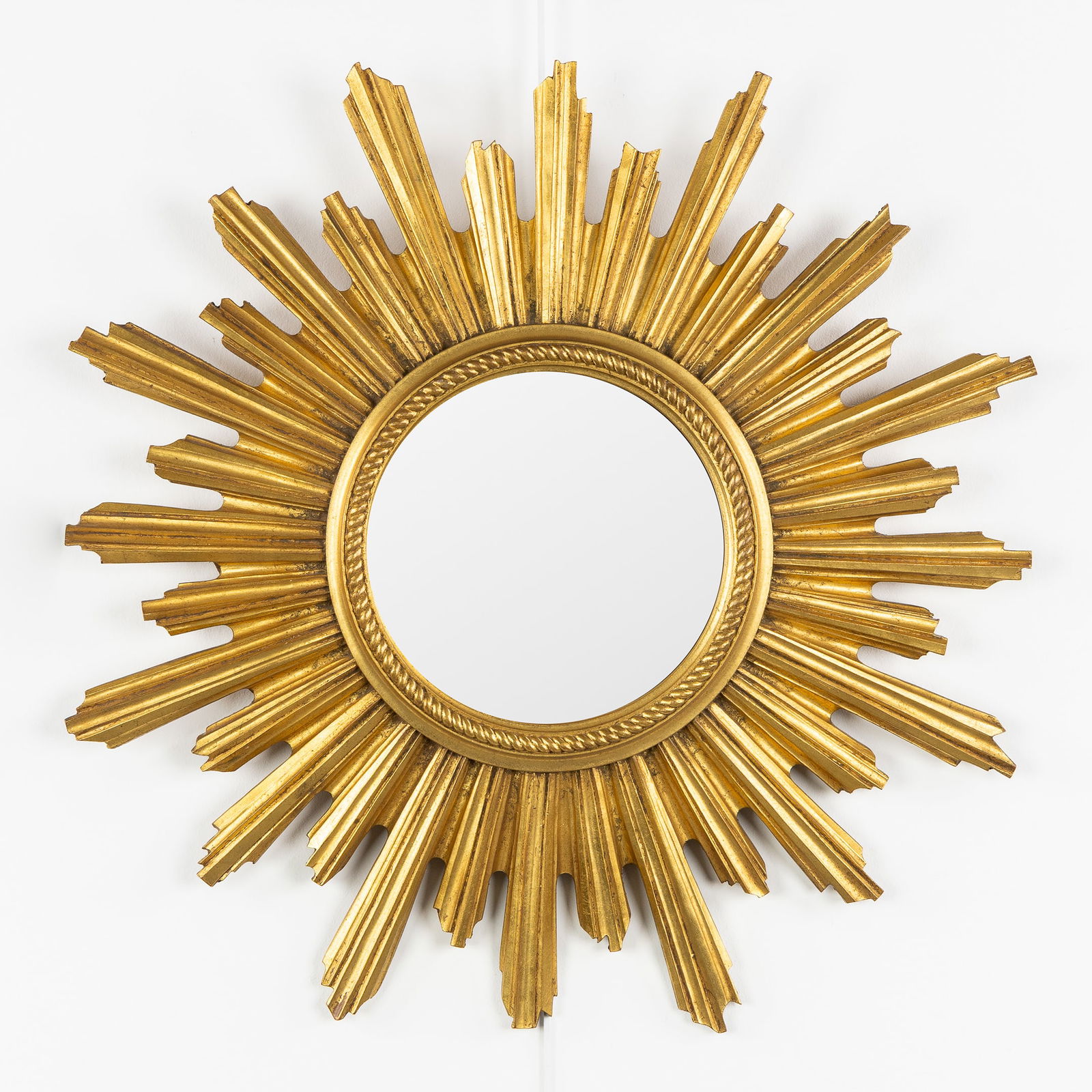 A Mid-Century Sunburst Mirror, Gilded, Convex Glass. Circa 1970.: A Mid-Century Sunburst Mirror, Gilded, Convex Glass. Circa 1970. Convex glass.Gilded resin.Circa 1970.