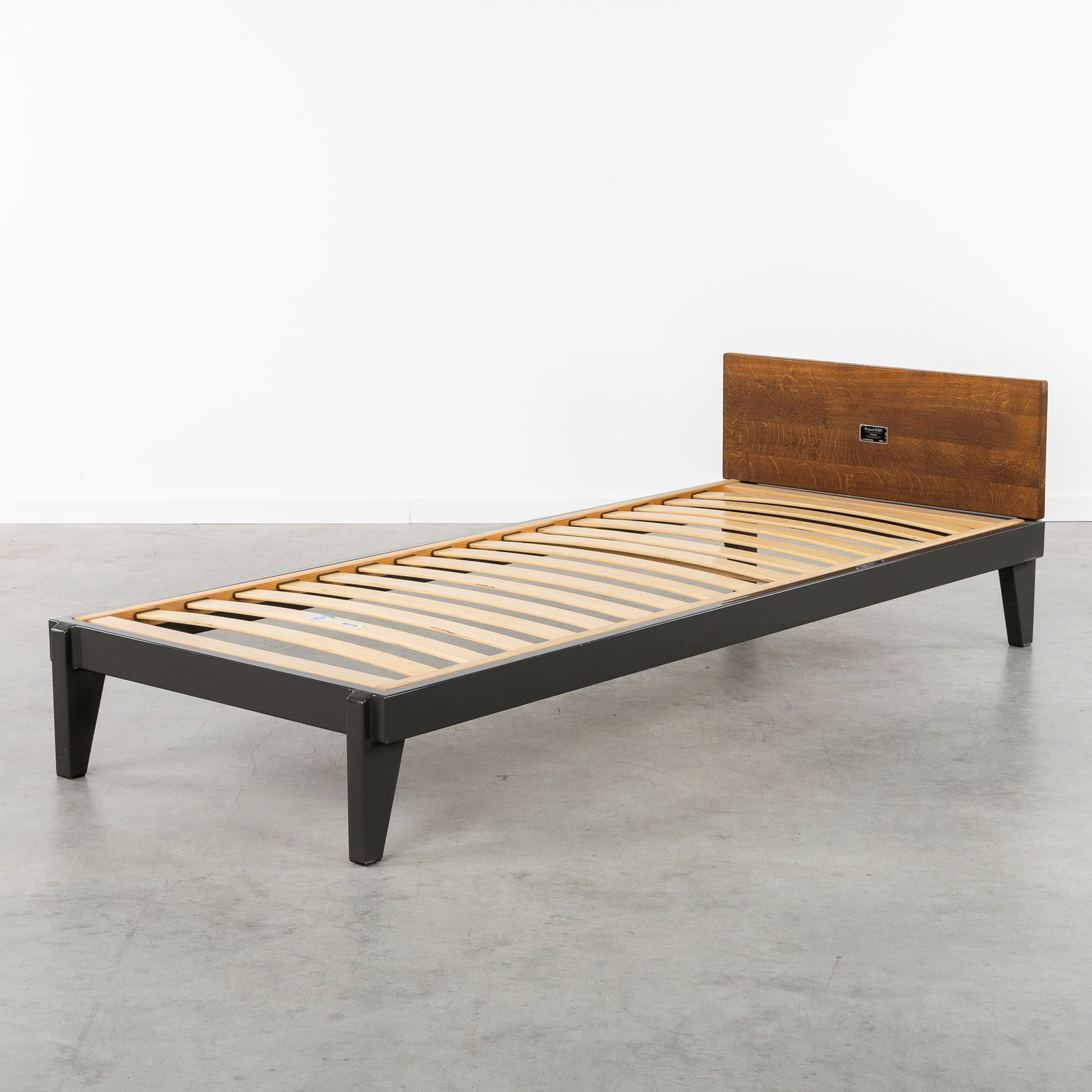 Jean Prouvé (1901-1984) 'Lit Flavigny', a Bed by G-Star Raw, for Vitra, Limited Reedition, no. 065: Jean Prouvé (1901-1984) 'Lit Flavigny', a Bed by G-Star Raw, for Vitra, Limited Reedition, no. 065 (2011) Patinated metal and wood.Designed by Jean Prouvé in 1945, by G-Star Raw, for Vitra.Limited