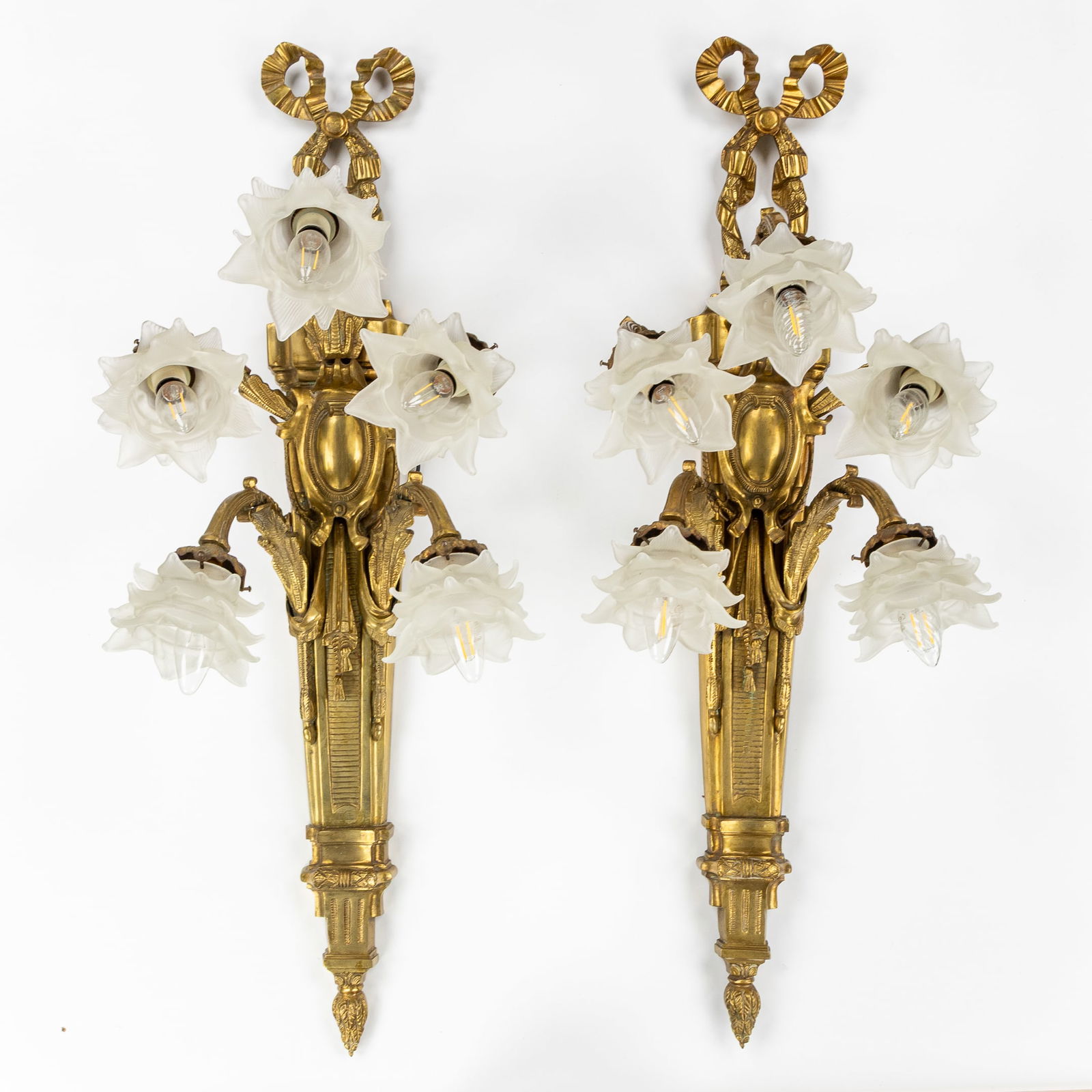 A Pair of Exceptionally Large Wall Lights or Appliqués, Gilded Bronze and Frosted Glass, Louis XVI: A Pair of Exceptionally Large Wall Lights or Appliqués, Gilded Bronze and Frosted Glass, Louis XVI style. Gilded bronze and frosted glass.Wall lights or appliqués with floral glass lampshades.Five l