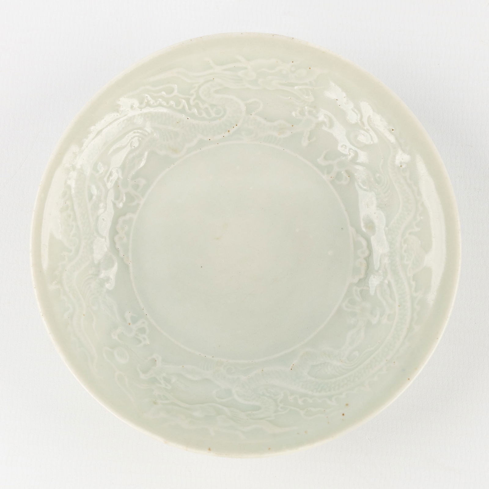 A Chinese Celadon Saucer, decorated in Relief with Dragon Figures. (1 of 4)