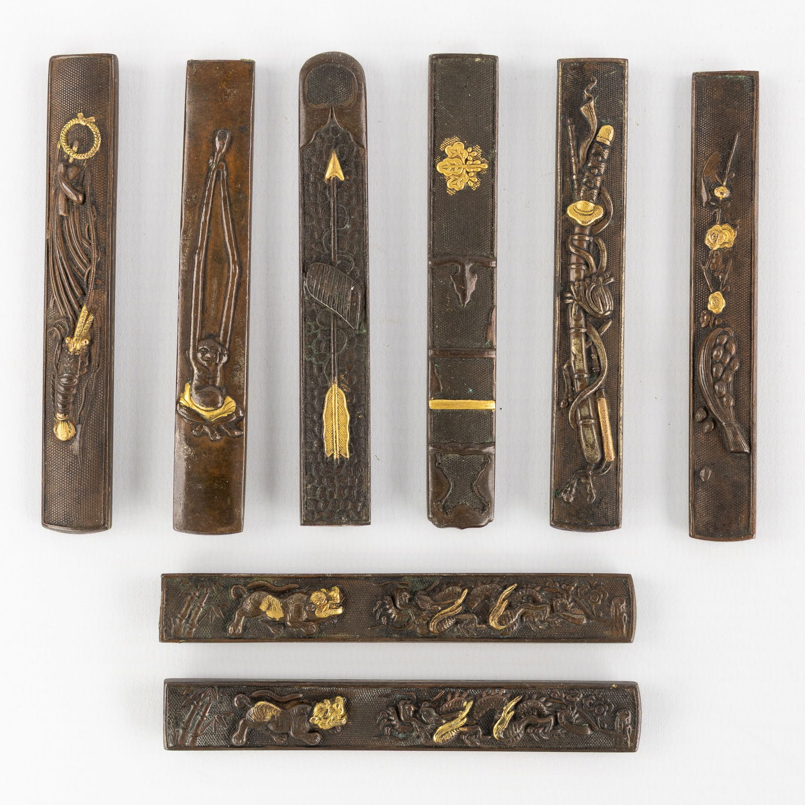 A Collection of eight Kozuka Knife Handles, Bronze/Shibuichi with Gilded Takazogan Decorations, (1 of 5)
