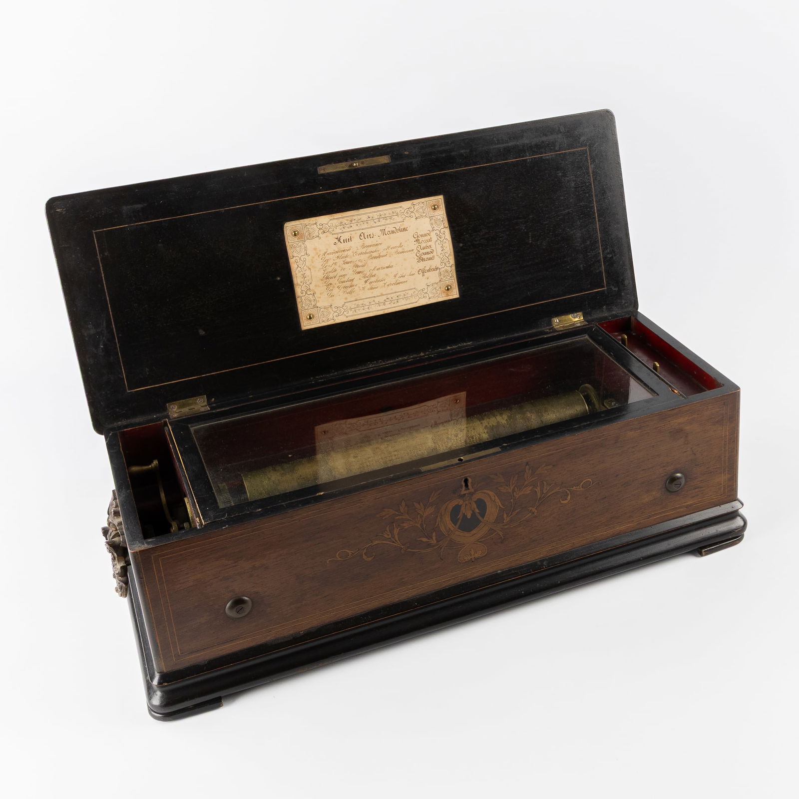 A Large Antique 'Mandolin' Music Box with Marquetry Inlay, Switzerland, late 19th: A Large Antique 'Mandolin' Music Box with Marquetry Inlay, Switzerland, late 19th century. Wooden box finished with marquetry inlay.Mounted with bronze handles.Music roll with 8 songs 'Airs