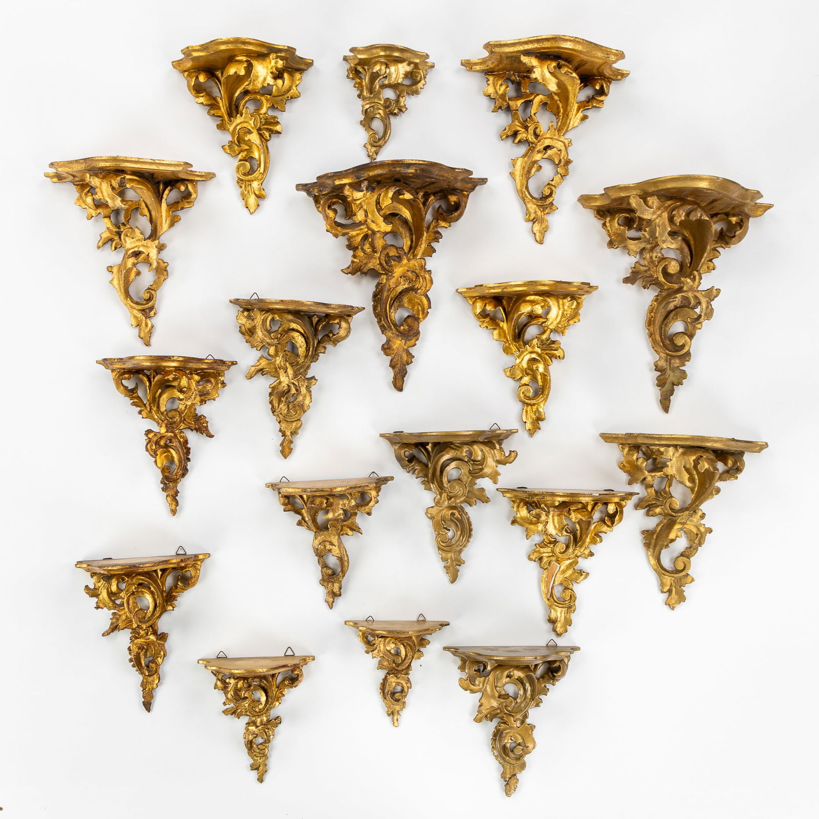 A Set of 17 Wood-Sculptured and Gilded Wall Consoles, Louis XV style.: A Set of 17 Wood-Sculptured and Gilded Wall Consoles, Louis XV style. Sculptured and gilded wood.Louis XV style.Various sizes. Dimensions of smallest: H: 10.5 cm x W: 11 cm x D: 6.5 cmDimensions of