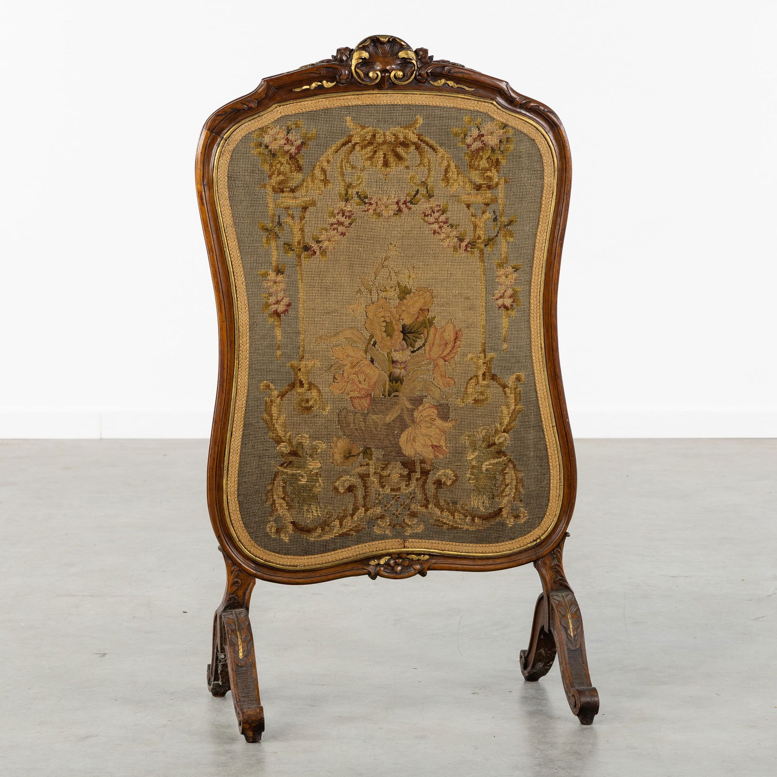 A Wood-Sculptured Fire Screen with Floral Embroidery, Louis XV style, 19th C.: A Wood-Sculptured Fire Screen with Floral Embroidery, Louis XV style, 19th century. Sculptured wood, with gilded accents.Embroidery decorated with a flower vase.Louis XV style, 19th century.