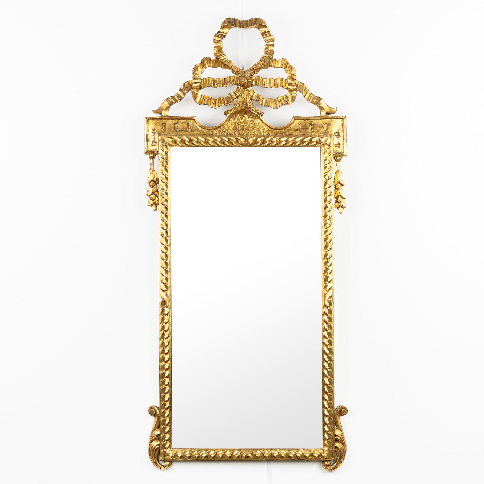 A Wood-Sculptured and Gilded Mirror, Louis XVI style, decorated with a Large Openworked Bow. 20th C. (1 of 6)